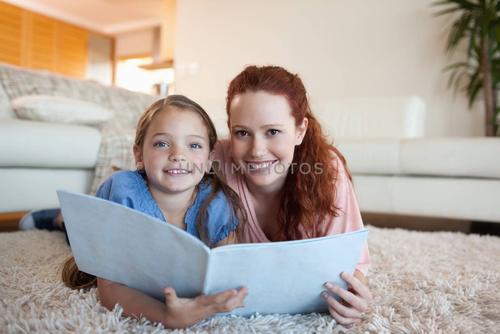 Mother and daughter looking at periodical together