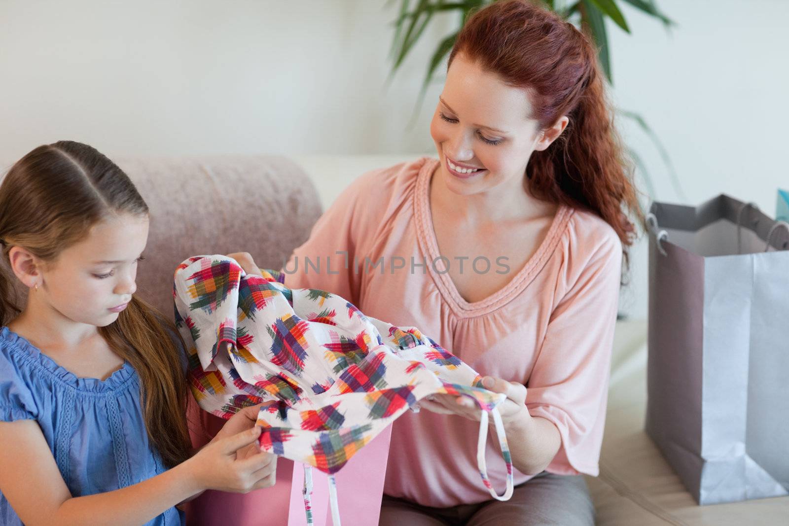 Mother and daughter with their shopping on the sofa