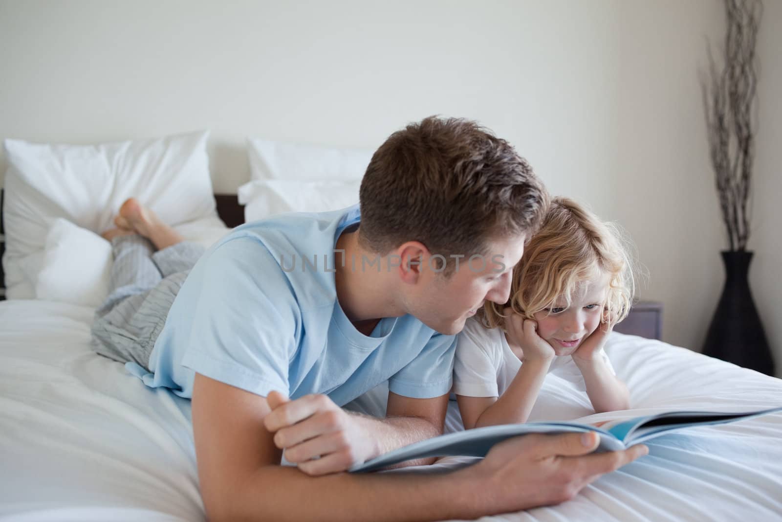 Father doing reading exercises together with his son