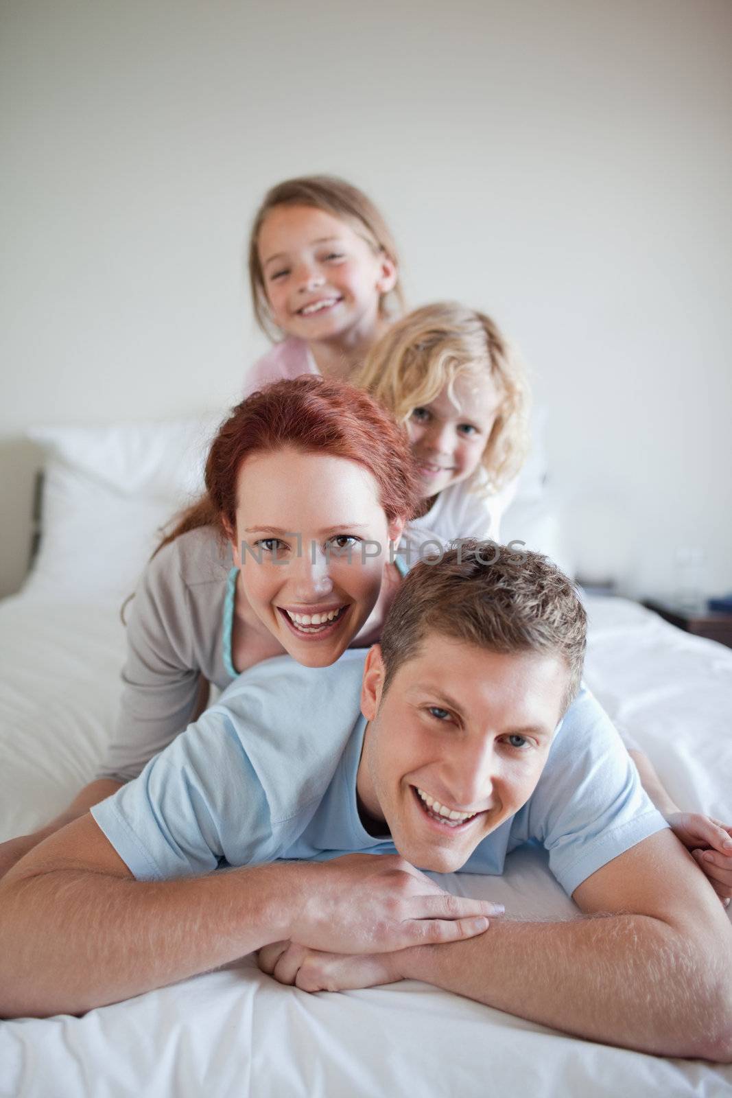 Family having fun together on the bed