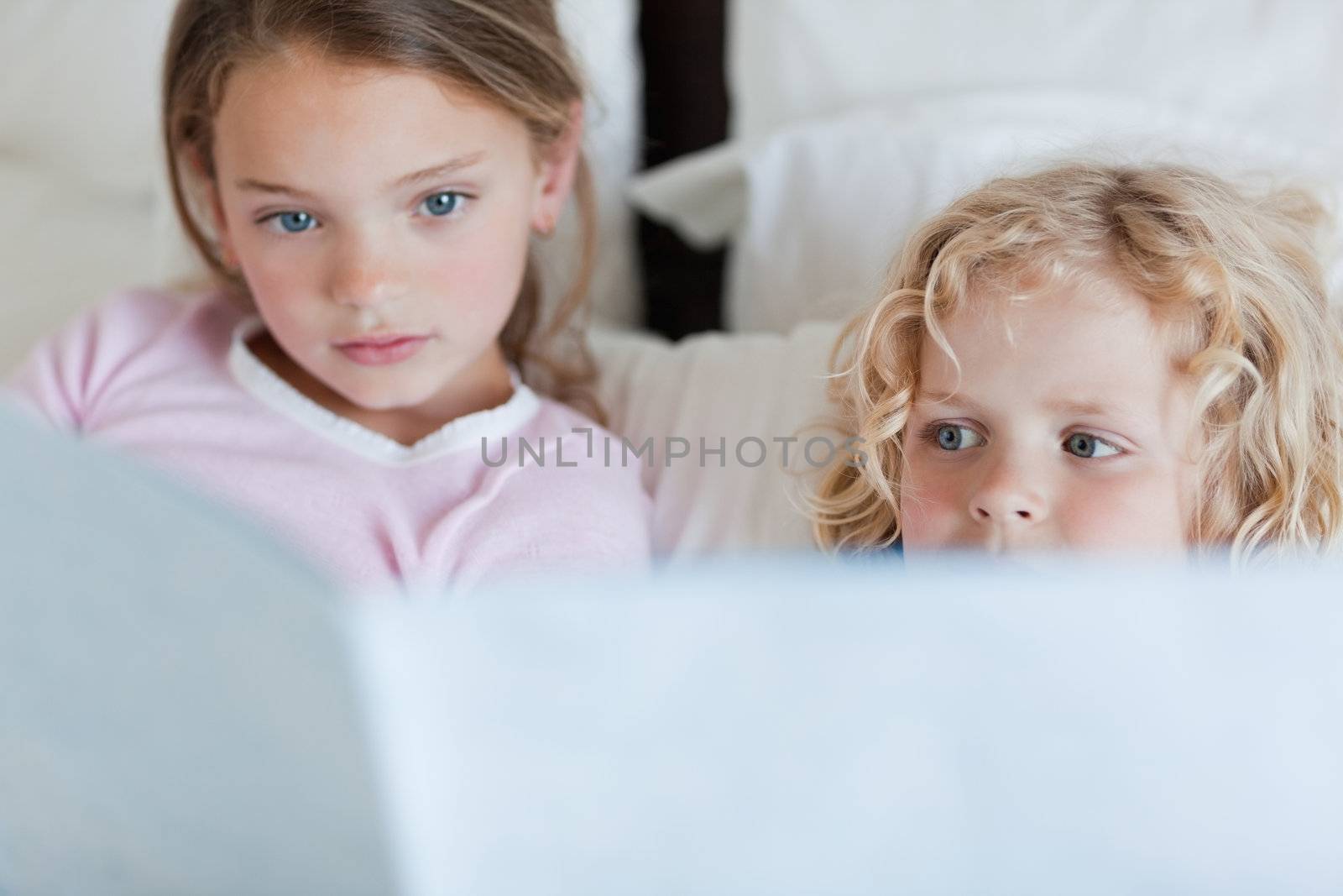 Siblings reading bed time story together