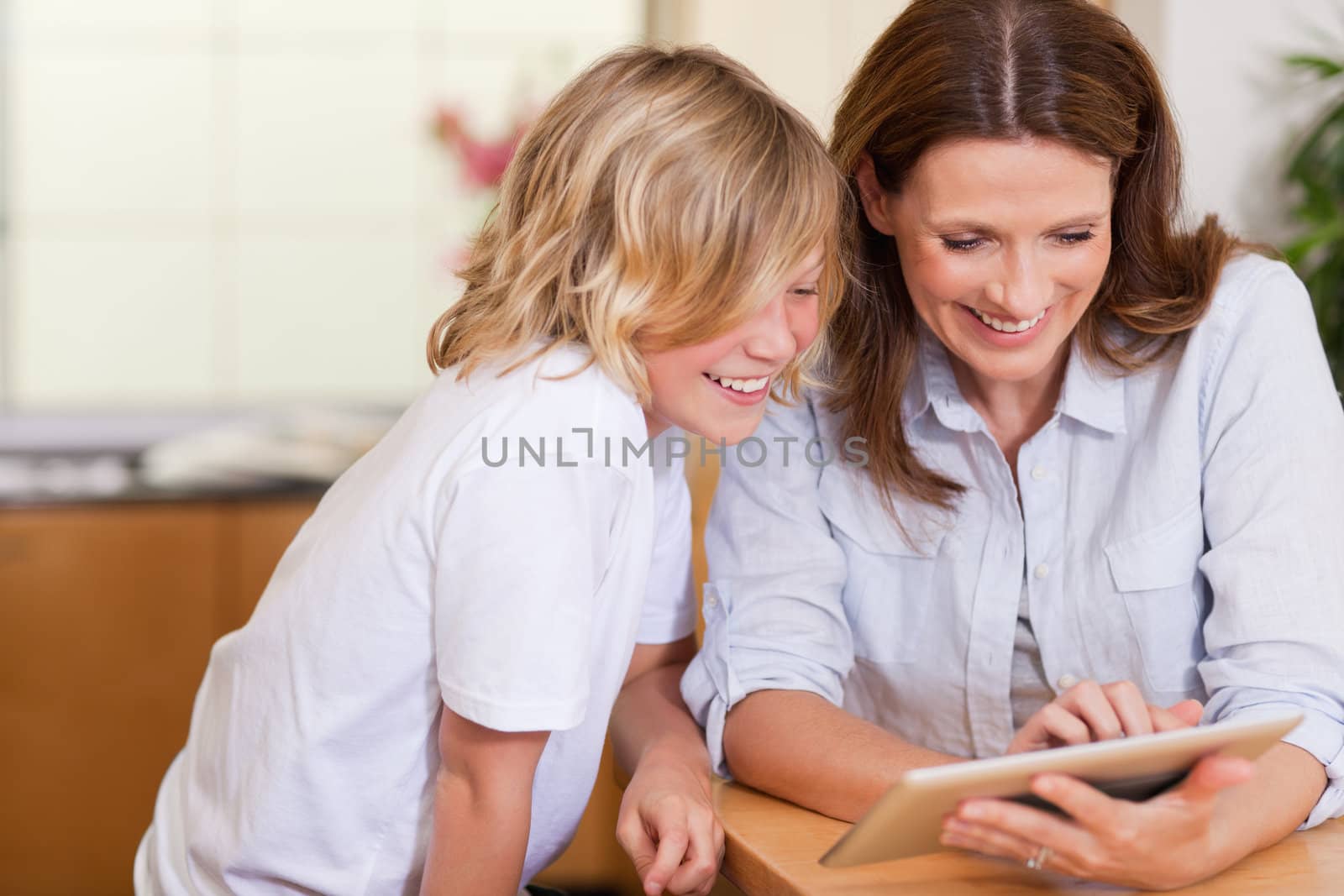 Mother and son using tablet together
