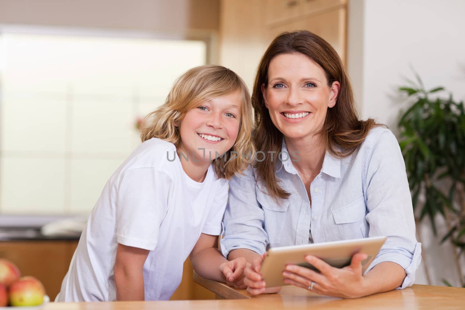 Woman and her son using tablet together