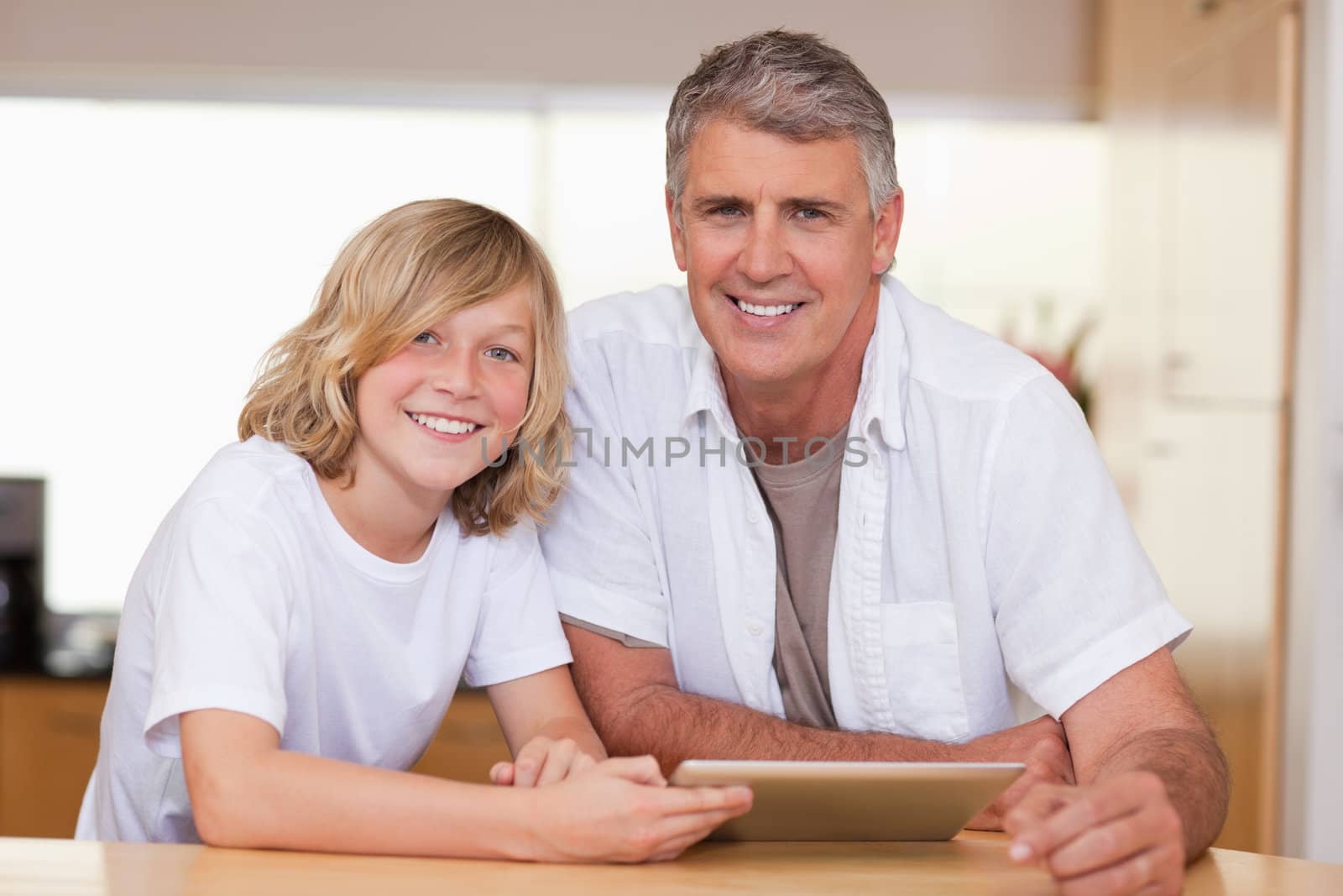 Boy and his father using tablet together