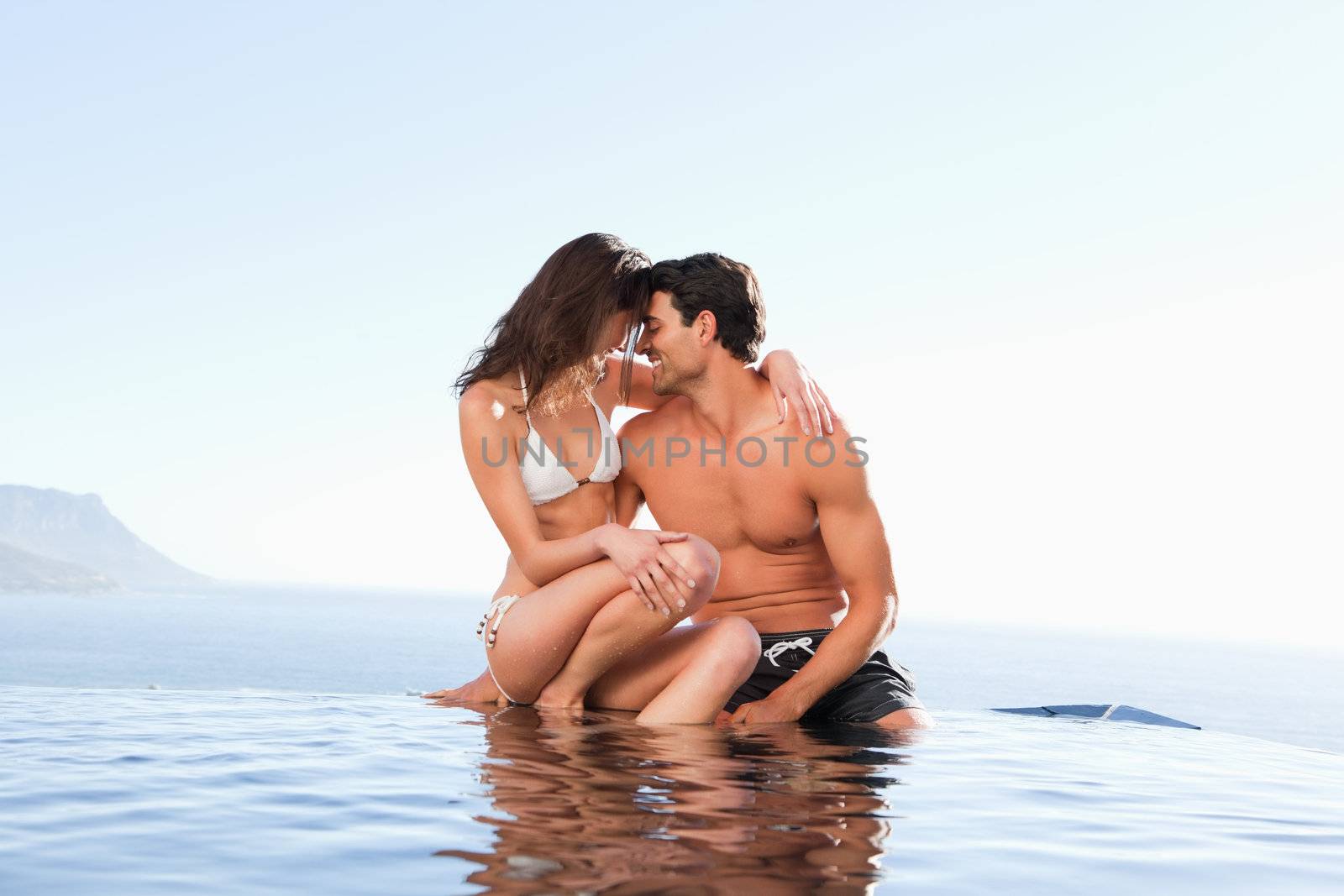 Couple on the pool edge together