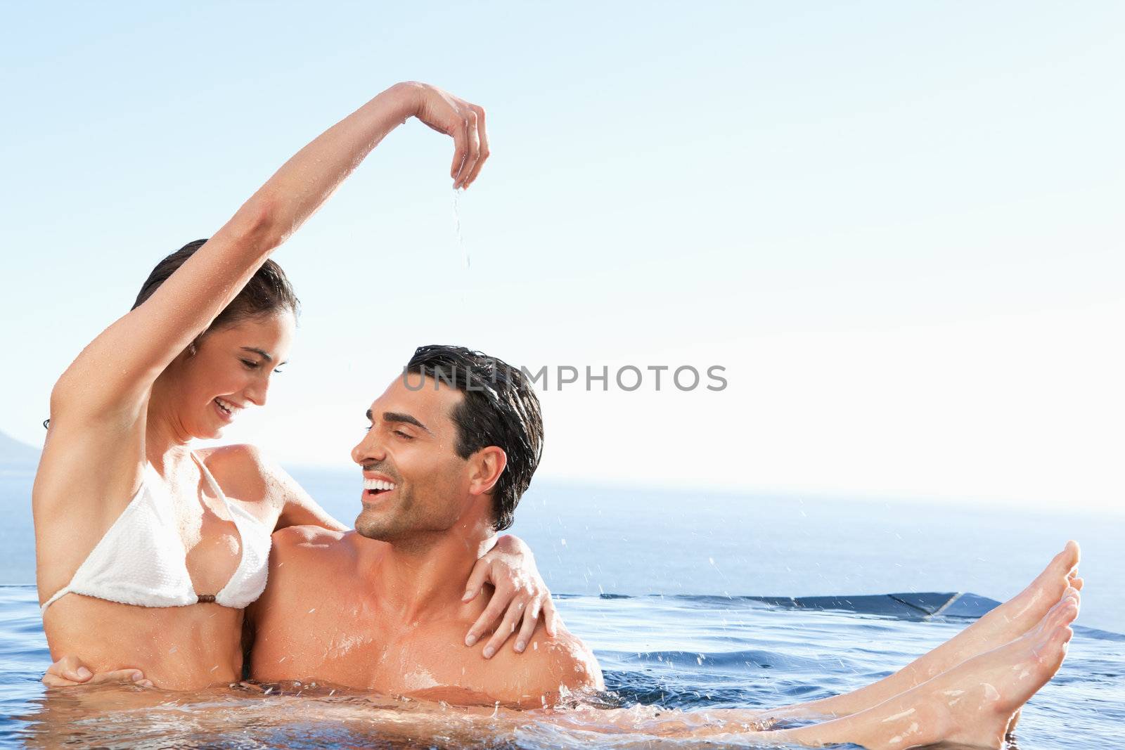 Happy couple enjoying their time together in the pool