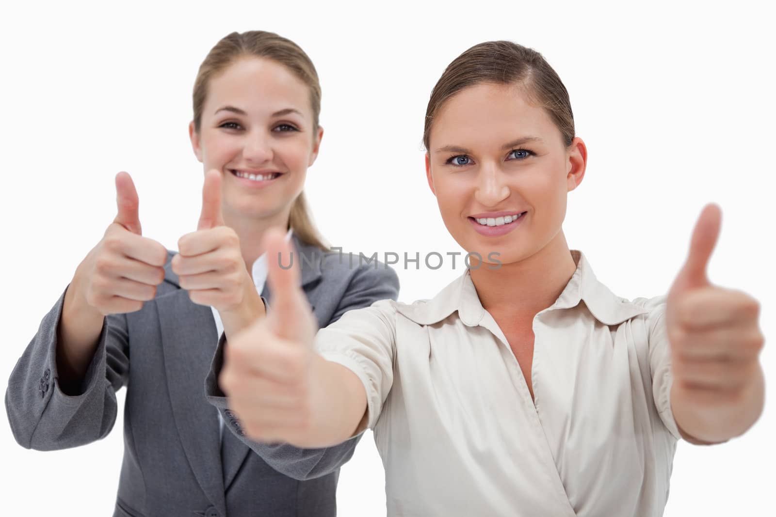 Businesswomen posing with the thumb up against a white background