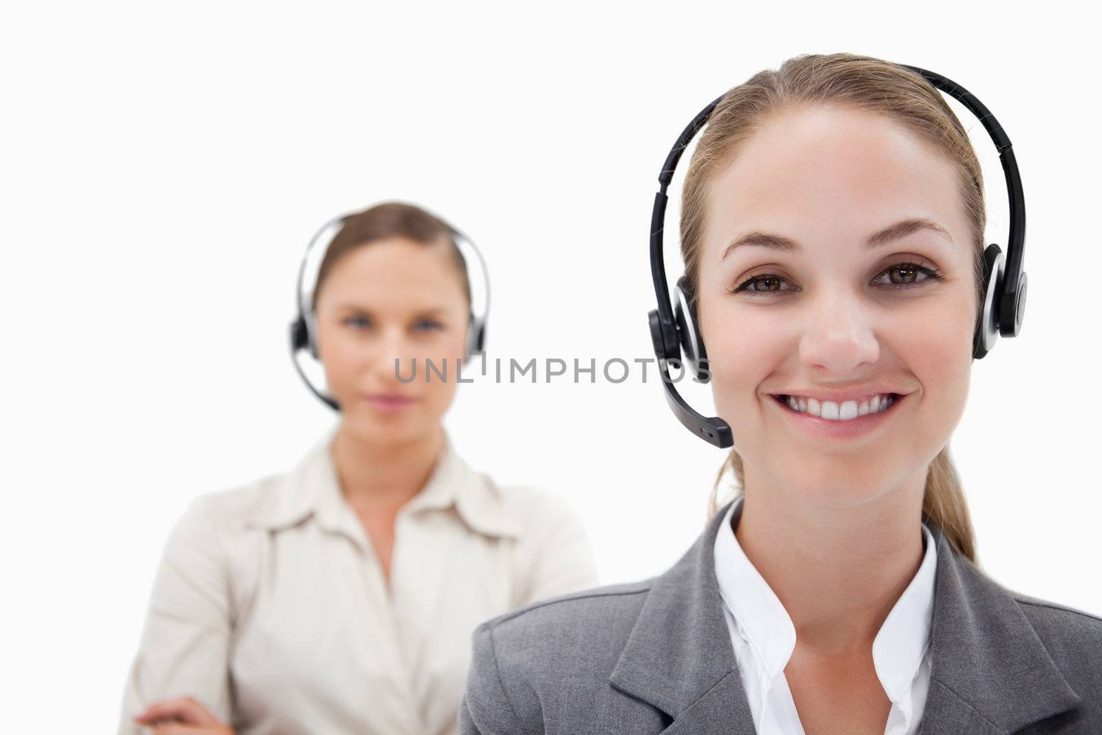 Smiling operators with headsets against a white background