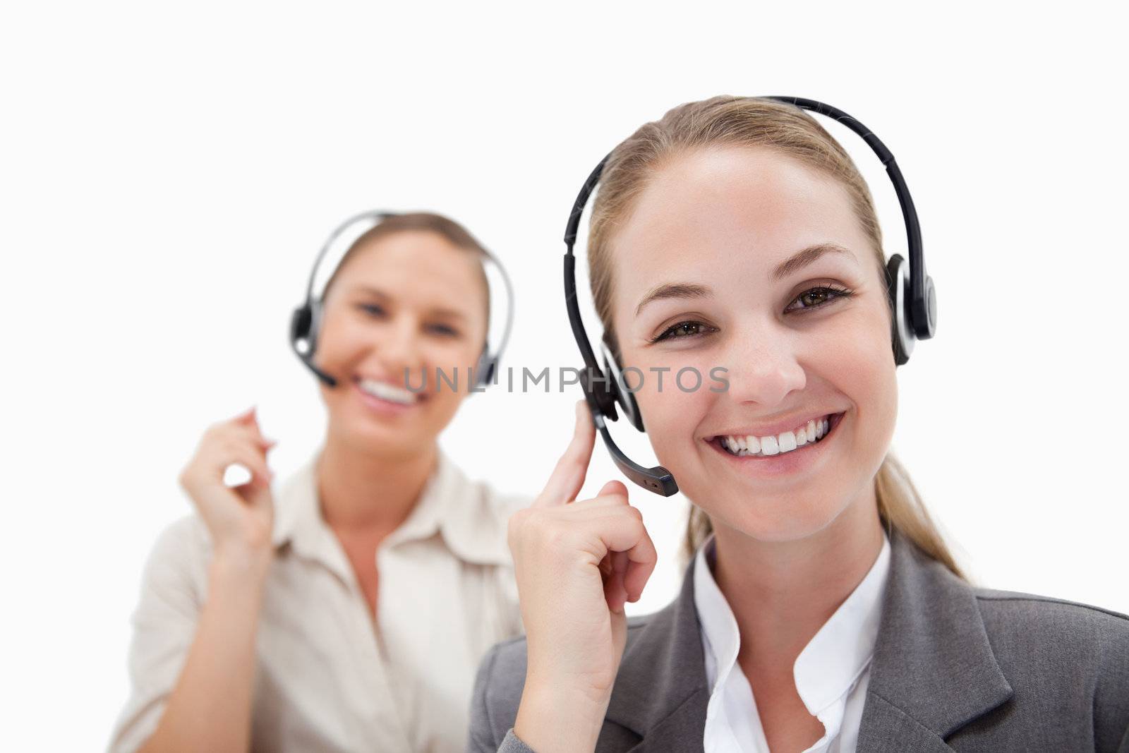 Joyful operators using headsets against a white background