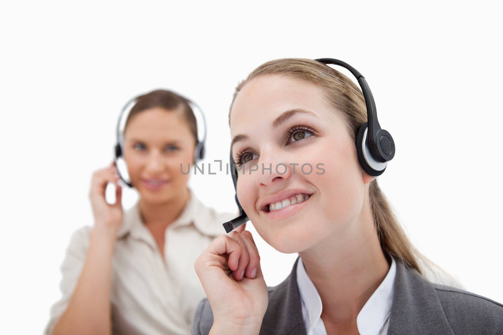 Smiling operators using headsets against a white background