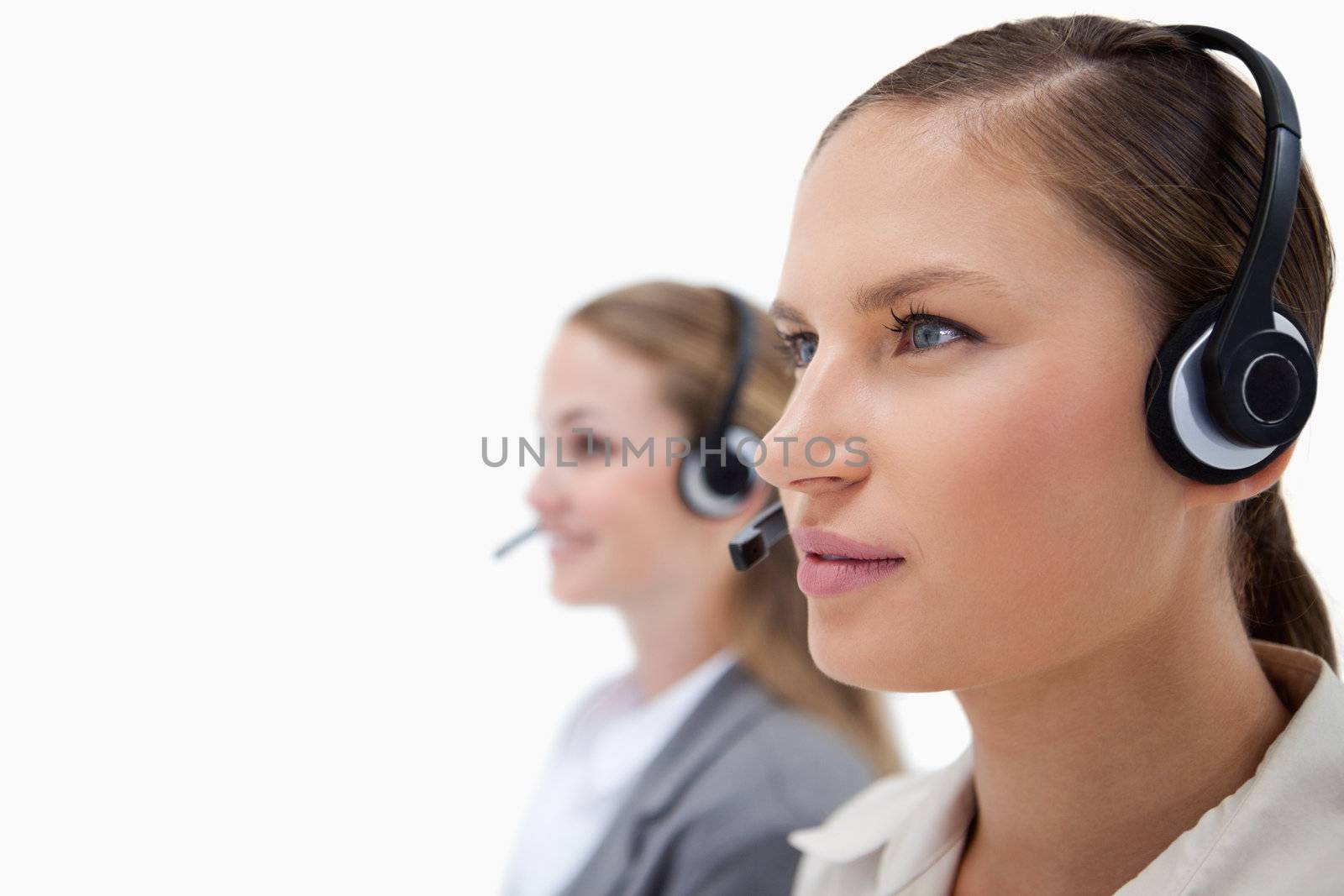Gorgeous operators using headsets against a white background