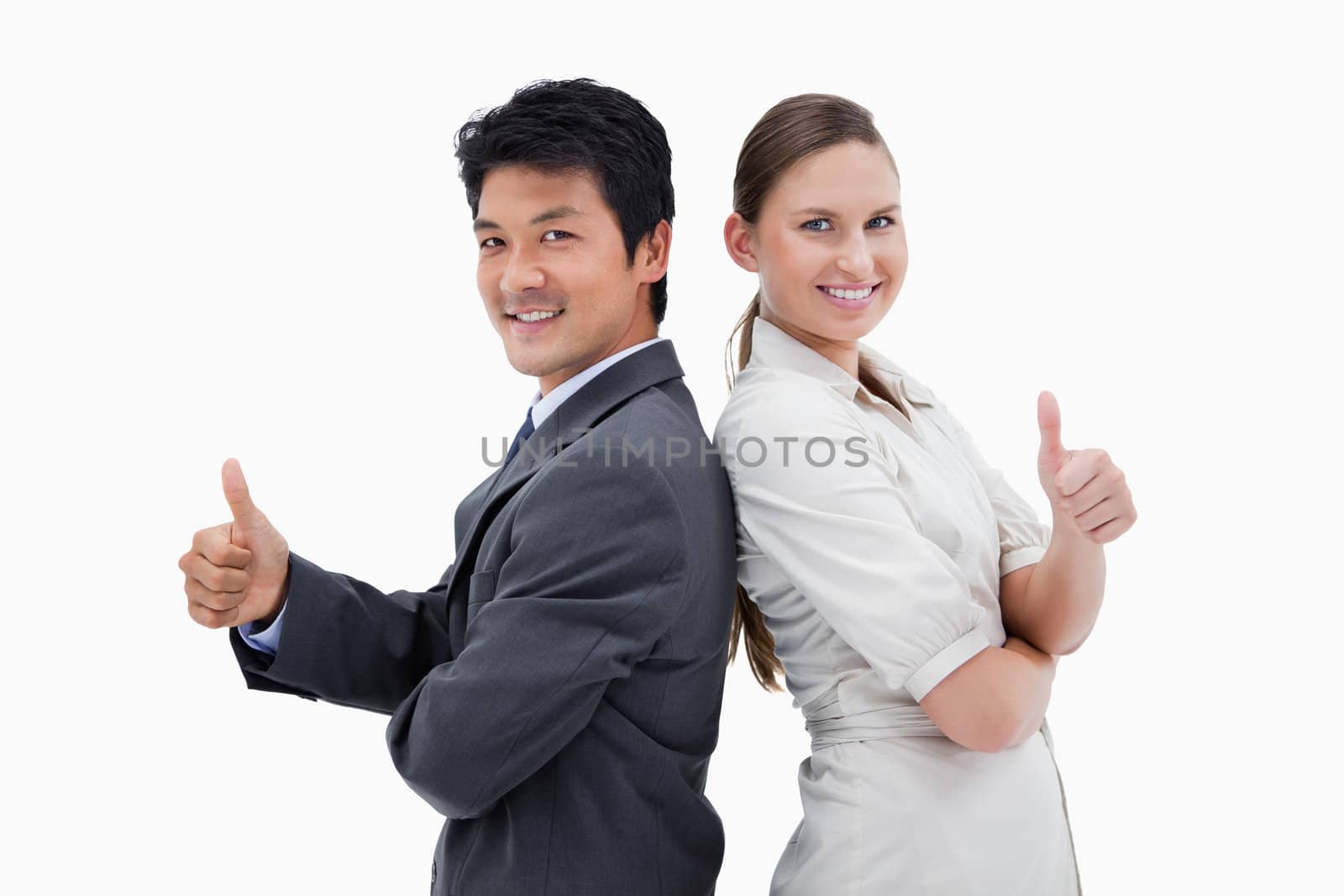 Business people standing back to back with the thumb up against a white background