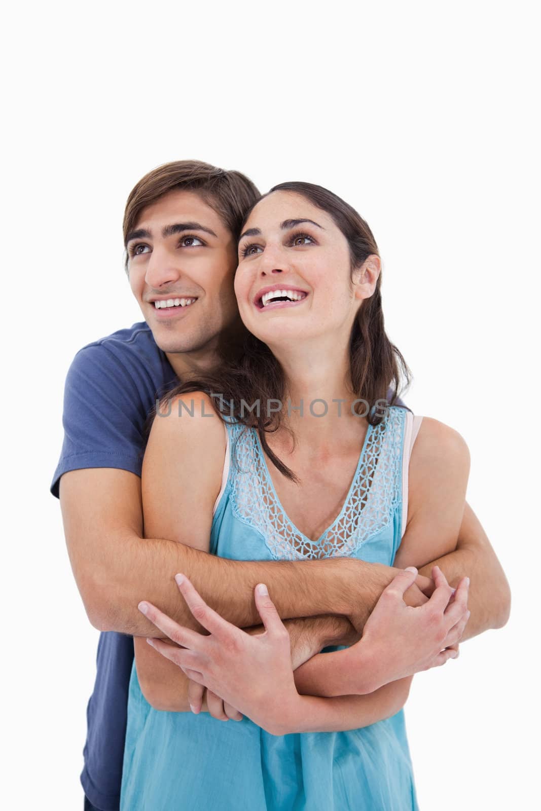 Portrait of an in love couple embracing each other against a white background