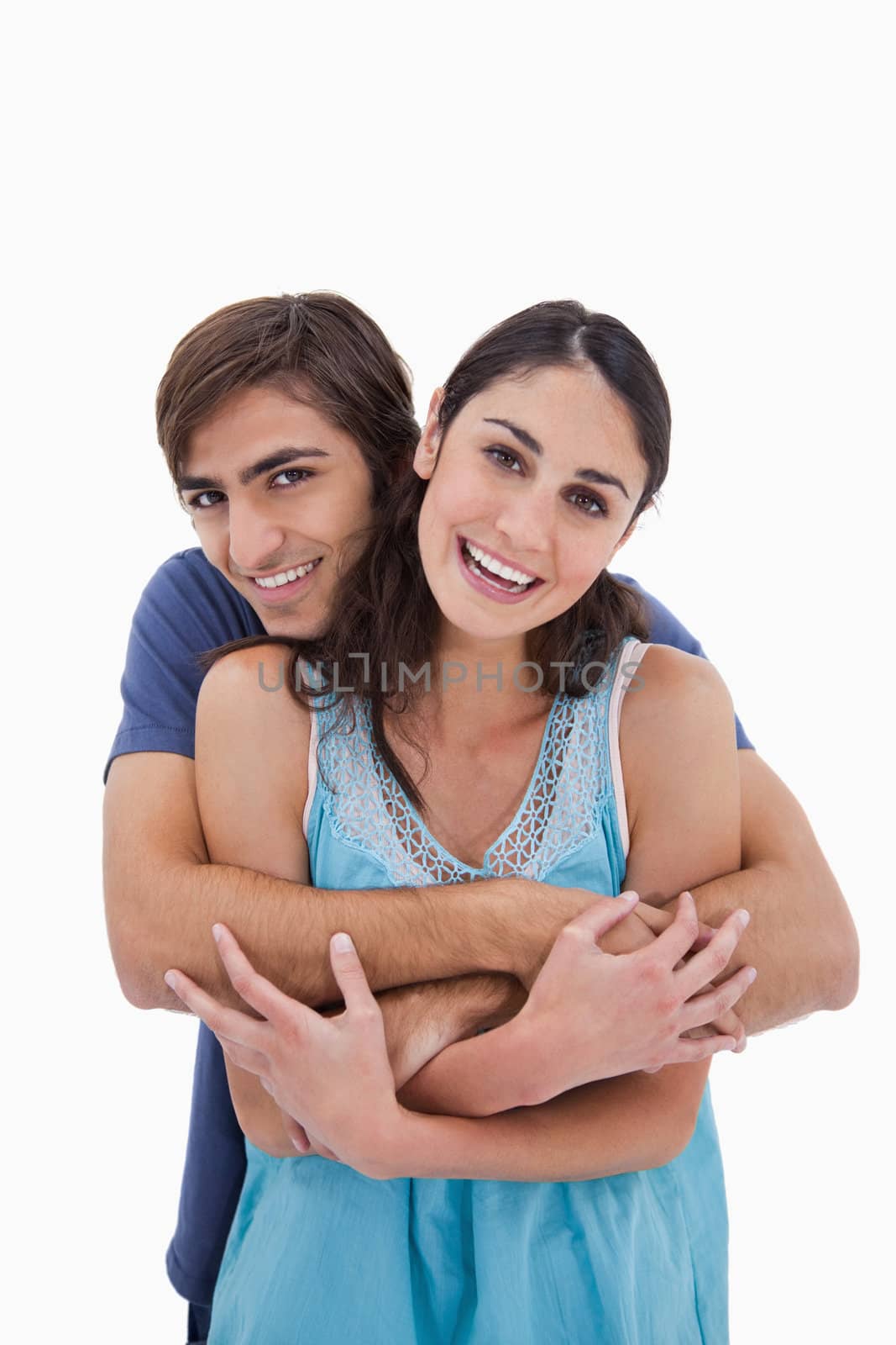 Portrait of a charming couple embracing each other against a white background