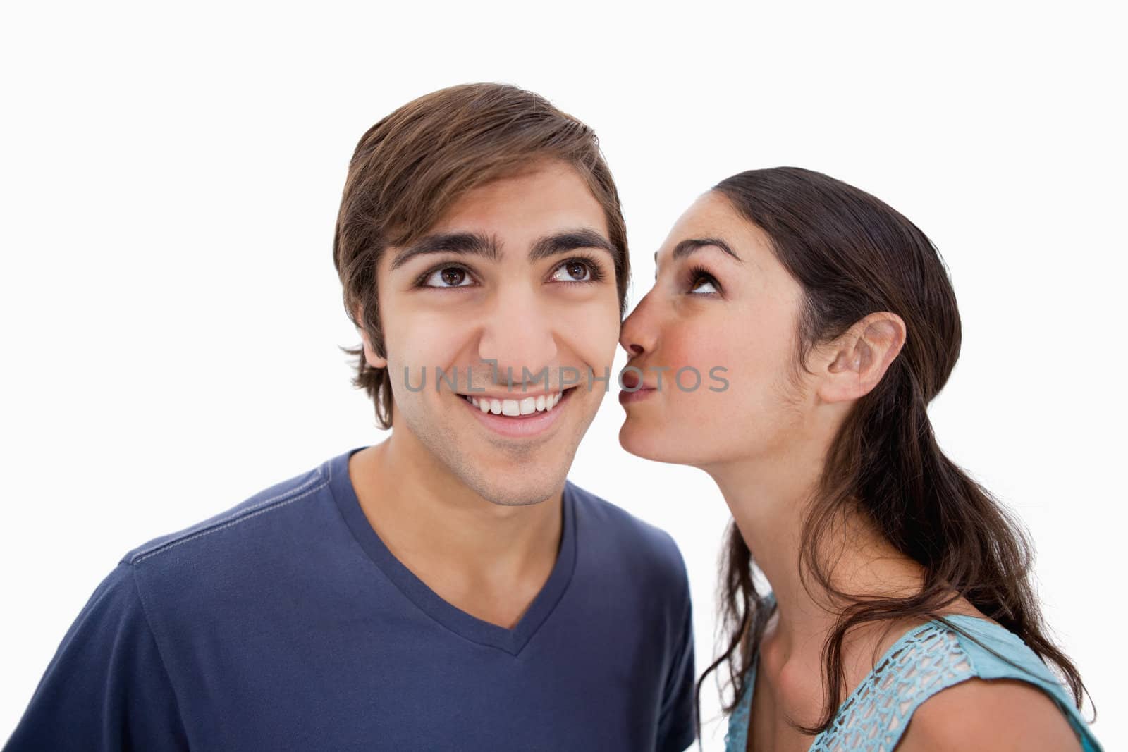 Lovely woman whispering something to her fiance against a white background