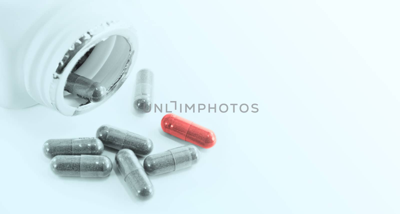 Capsules herbal drugs poured from a bottle