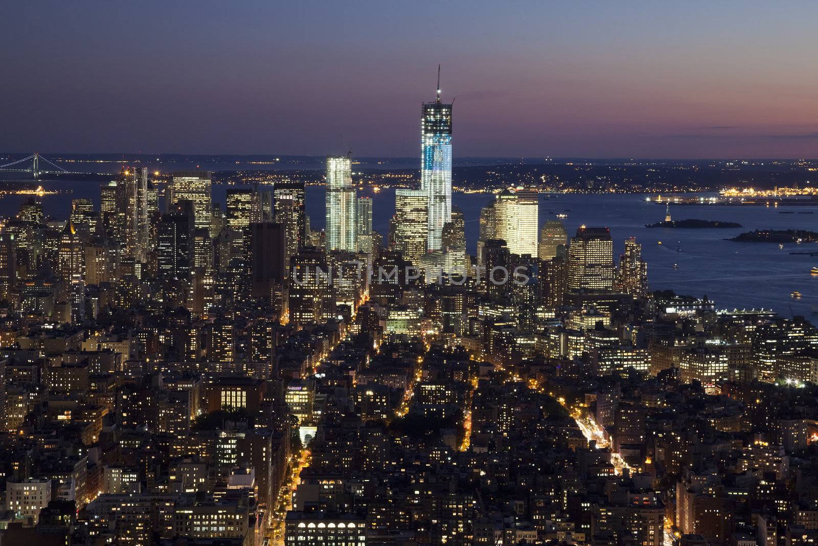 The New York City skyline at twilight w the Freedom tower