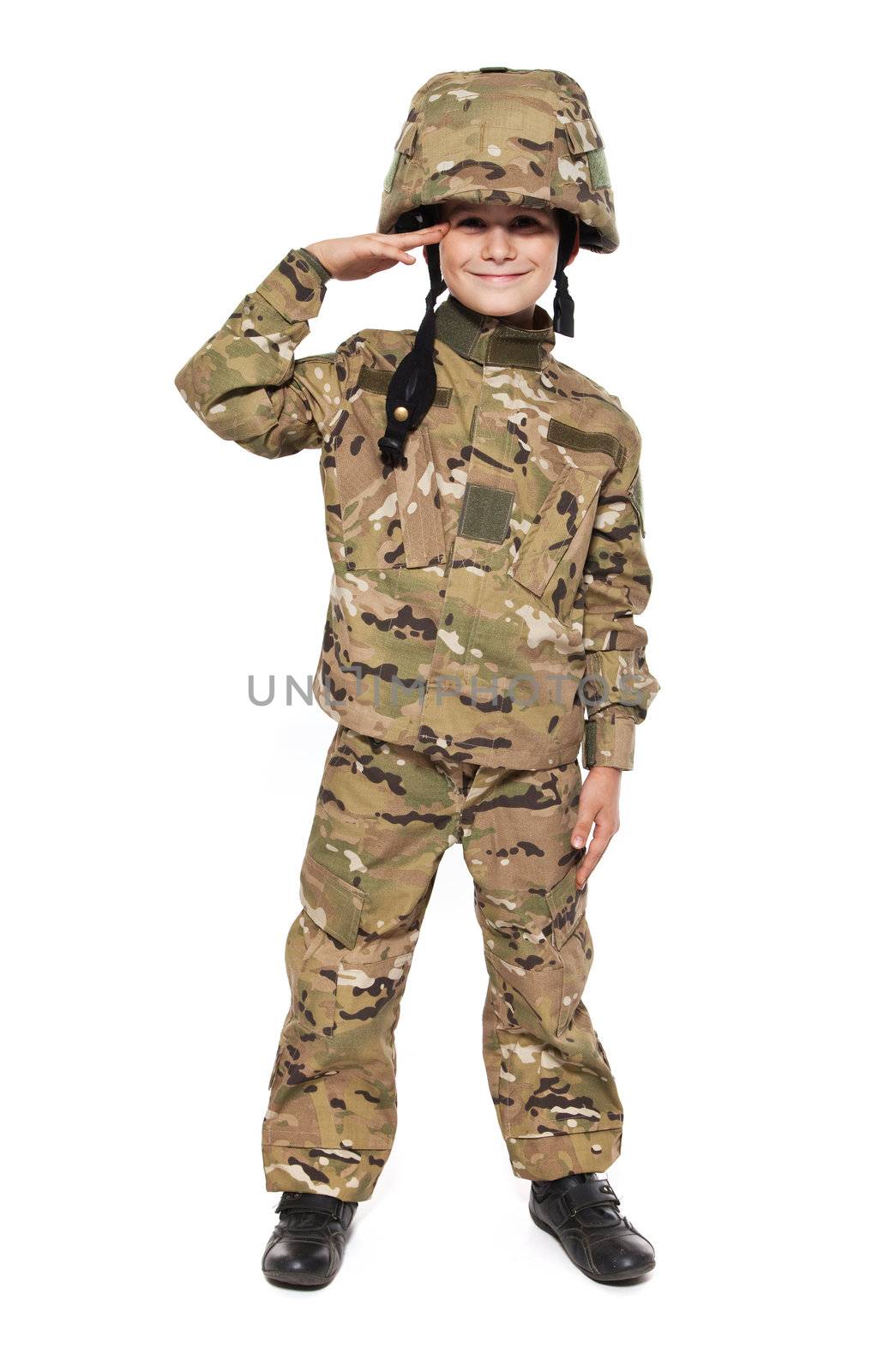 Saluting soldier. Young boy dressed like a soldier isolated on white