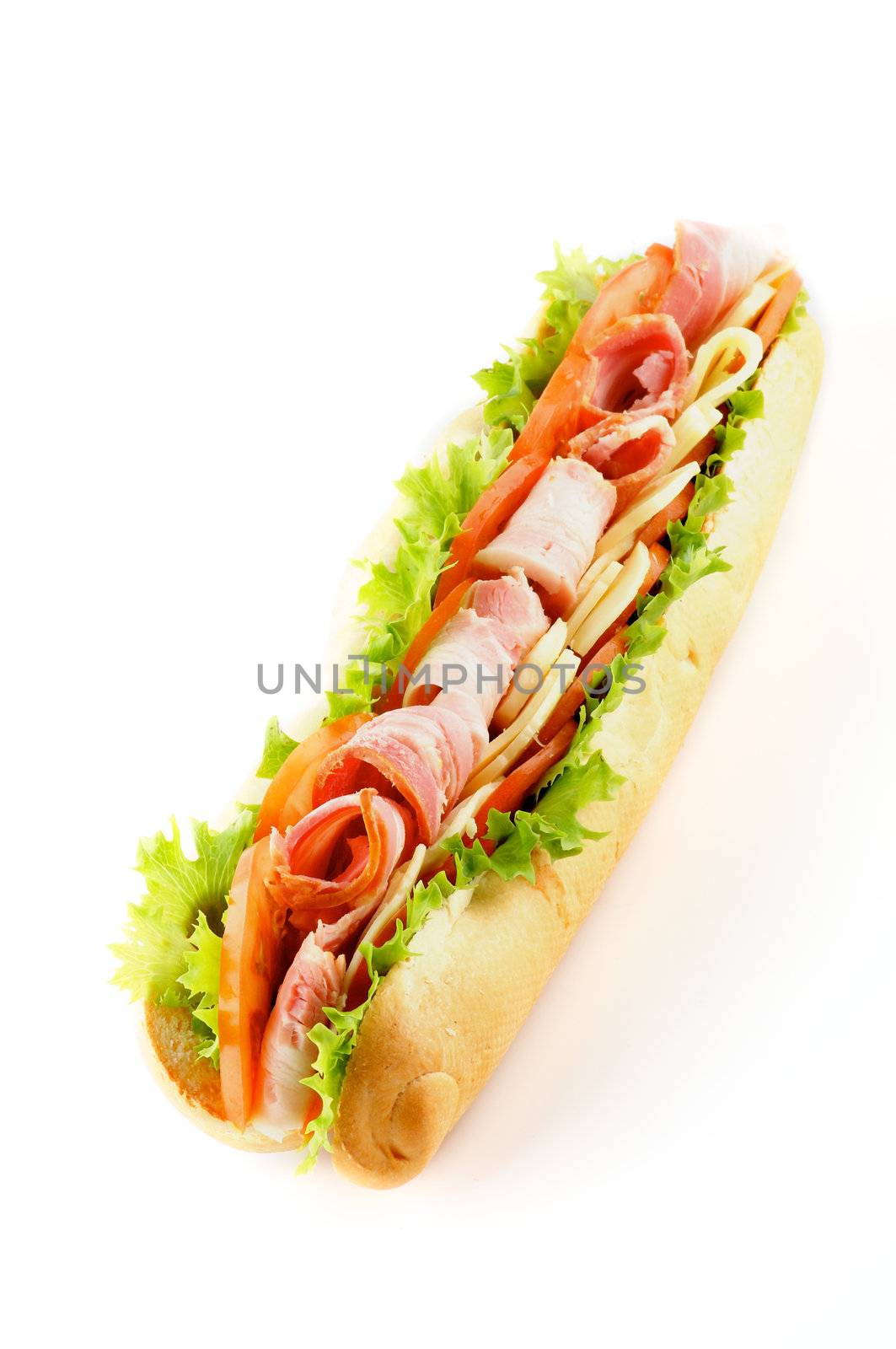 Long Baguette Sandwich with Lettuce, Tomatoes, Cheese and Ham isolated on white background