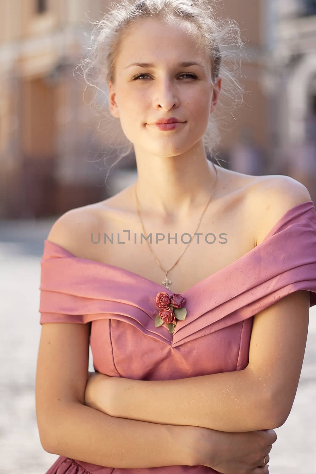 Portrait of a girl in a dress on a background of the city