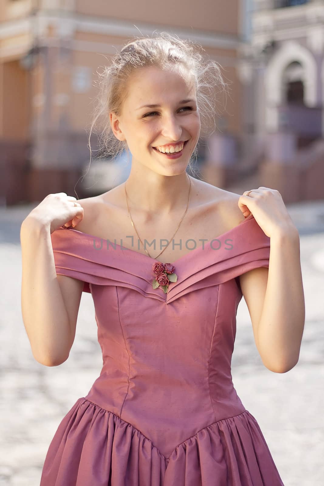 Portrait of a girl in a dress on a background of the city