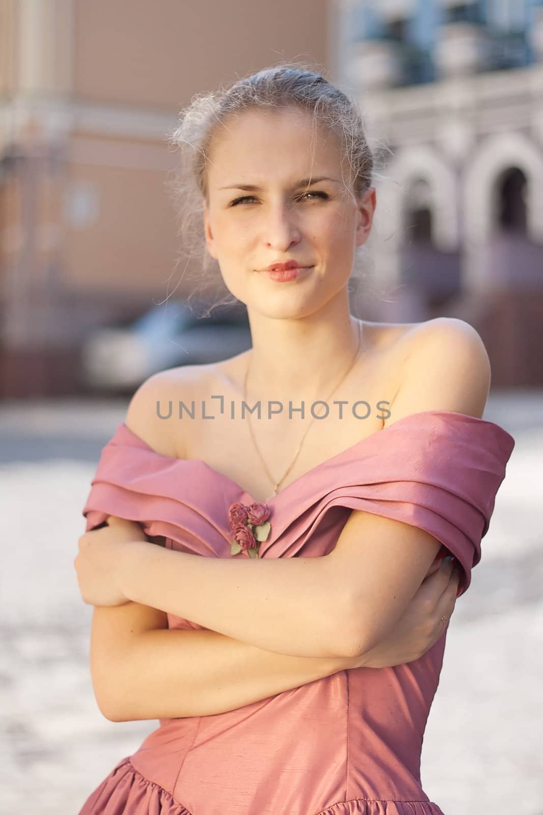 Portrait of a girl in a dress on a background of the city