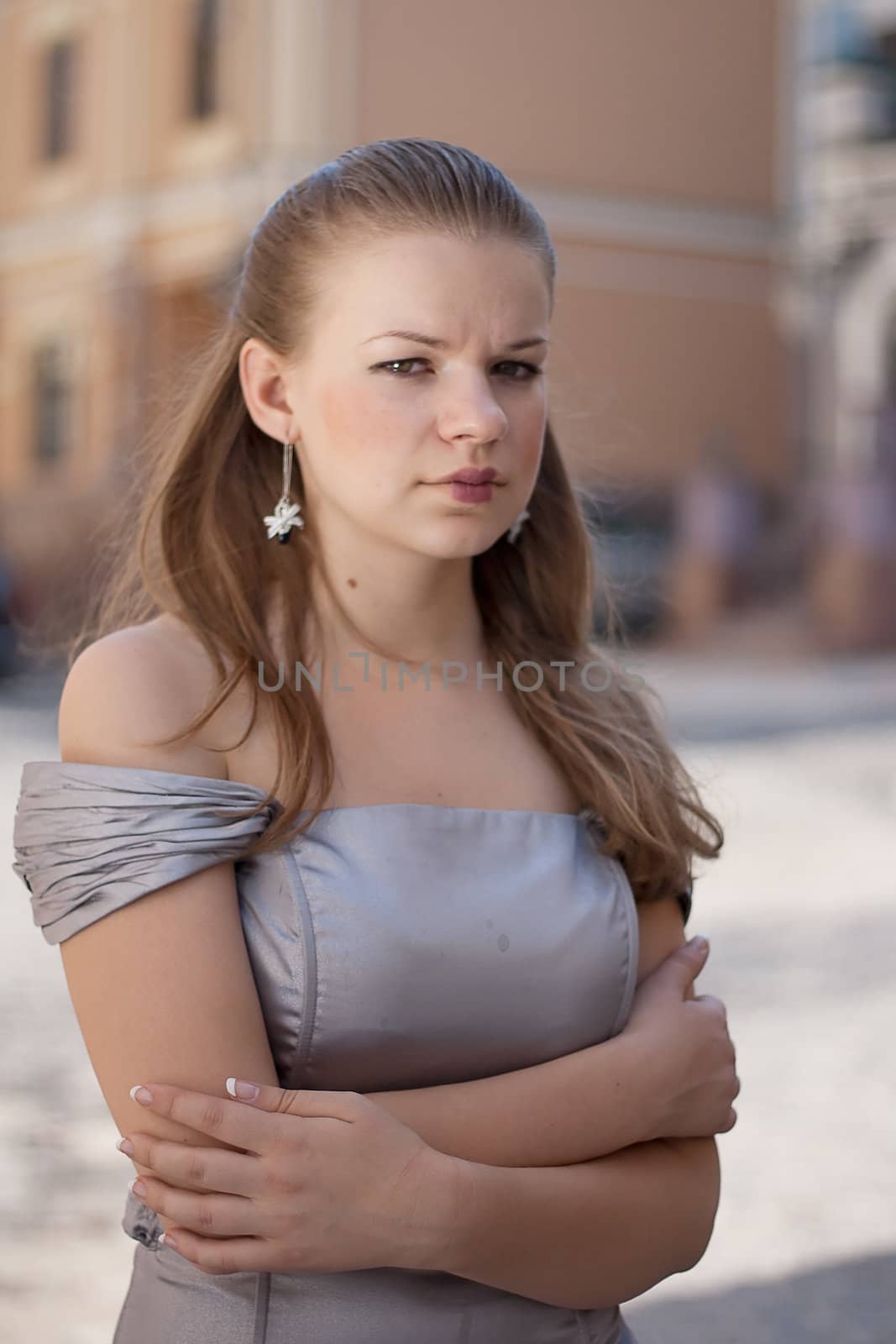 Portrait of a girl in a dress on a background of the city