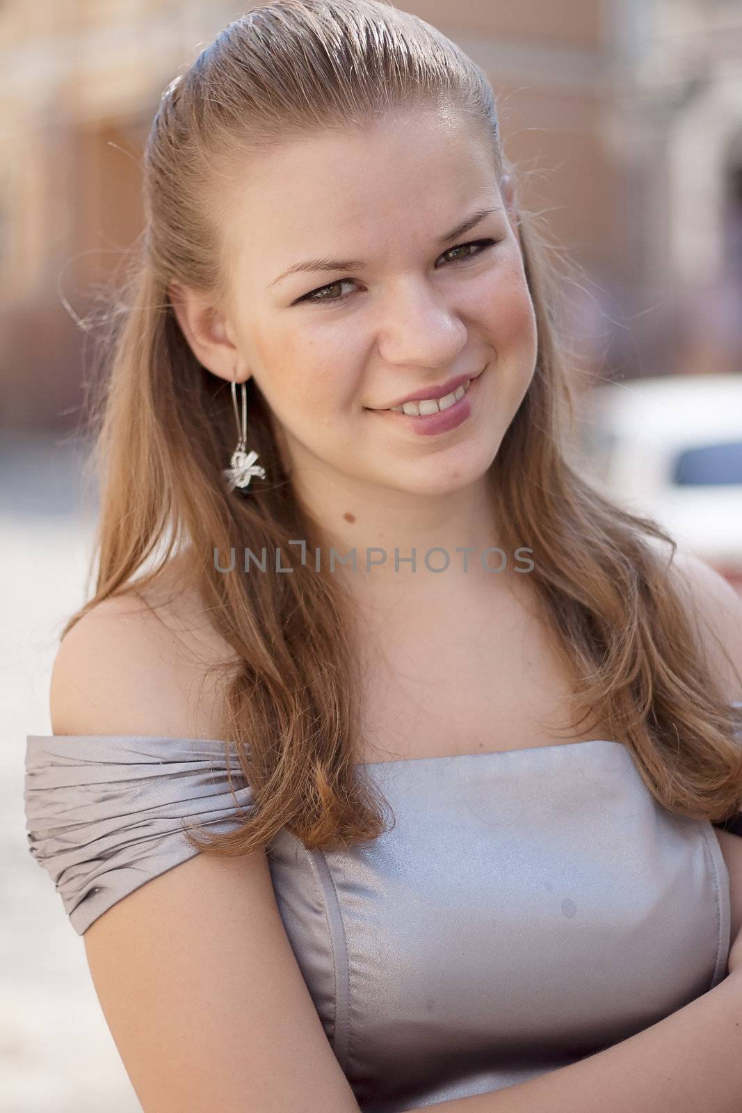 Portrait of a girl in a dress on a background of the city