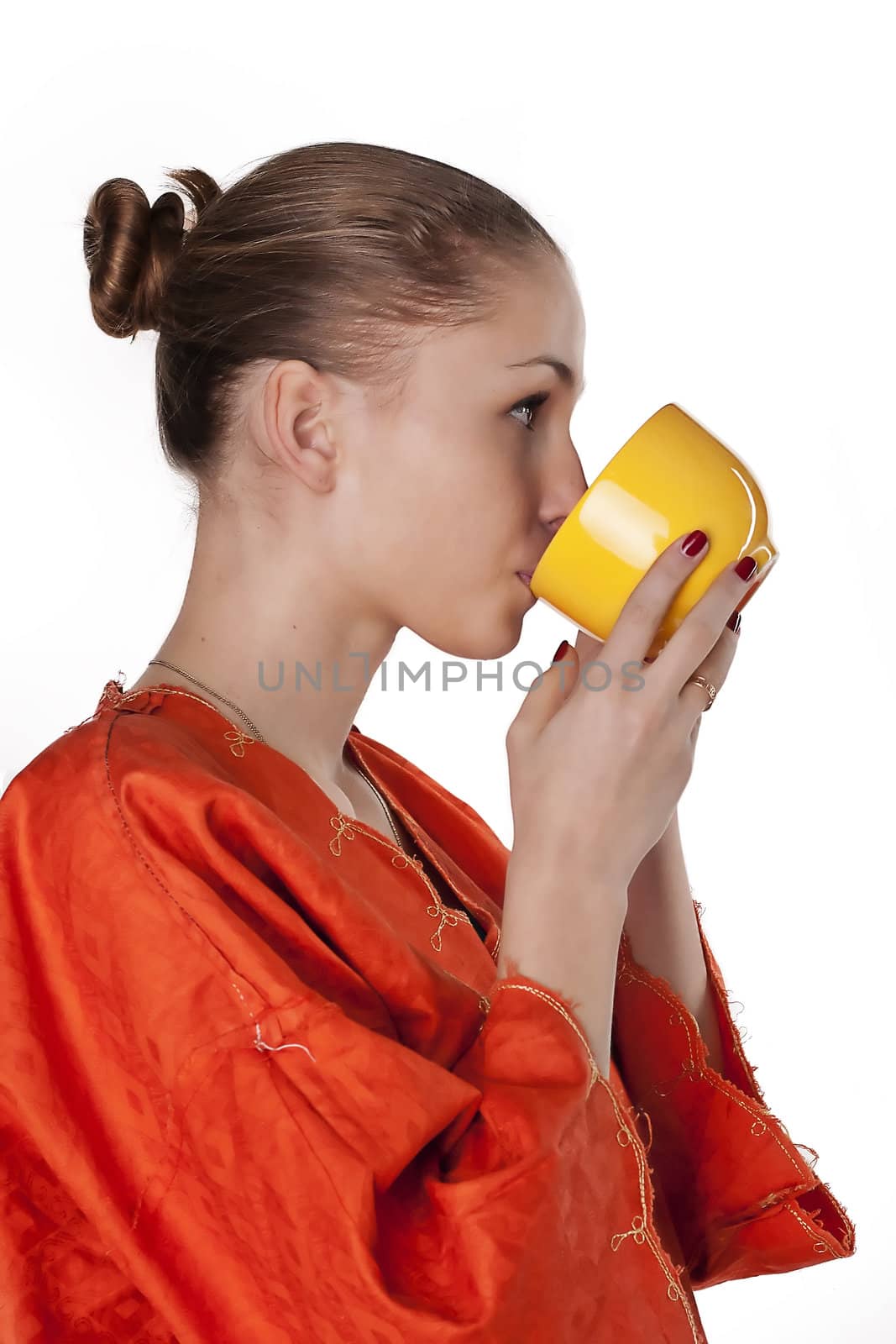 girl in a dress drink from a cup  Studio photography