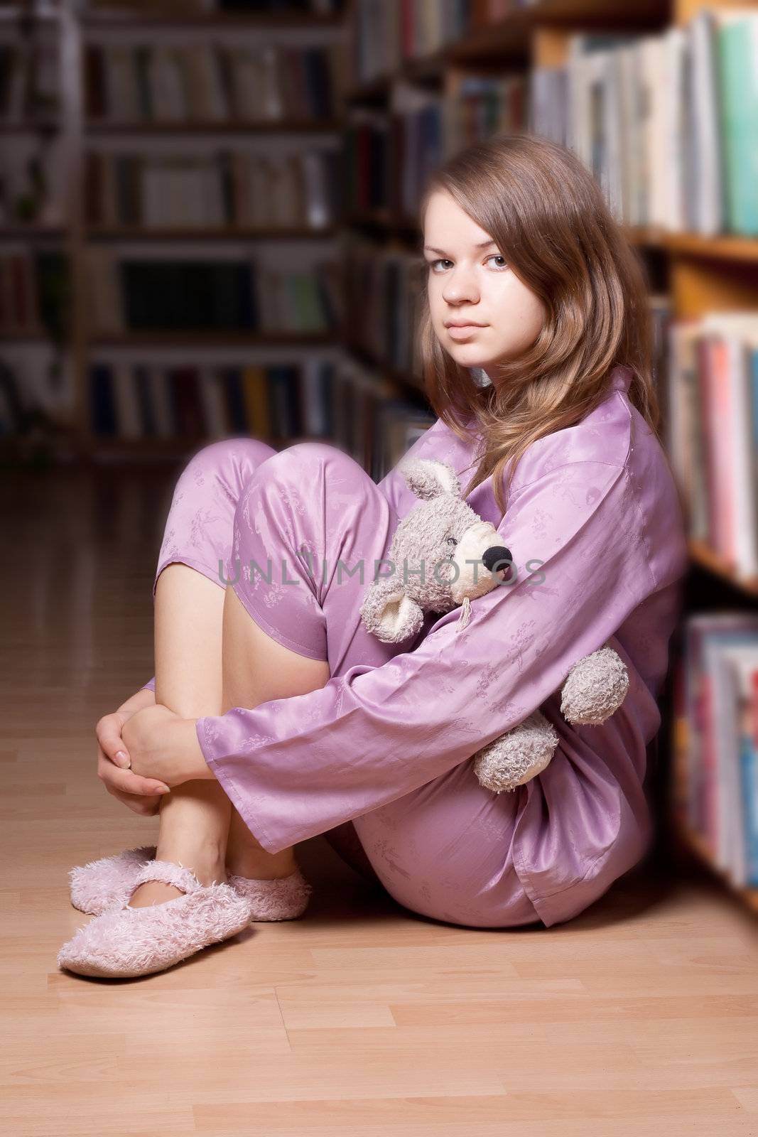 The girl in pink pajamas in the library by victosha