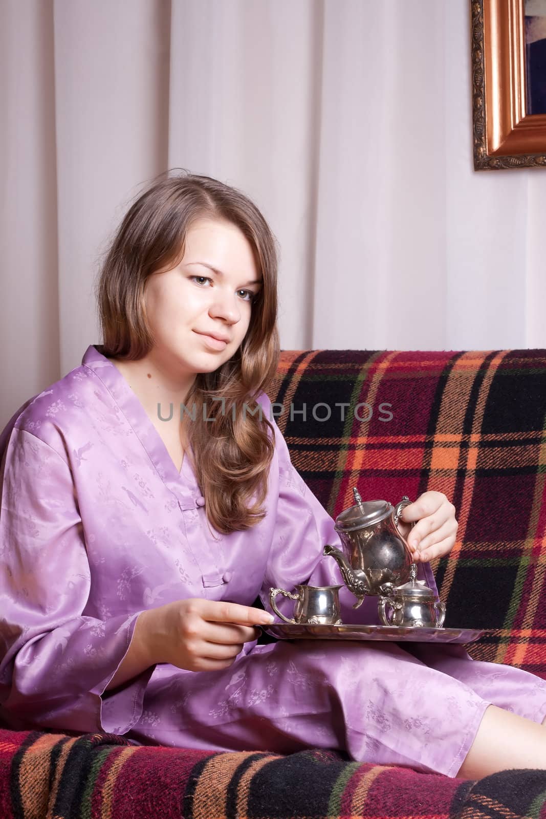 The girl in purple pajamas in the room