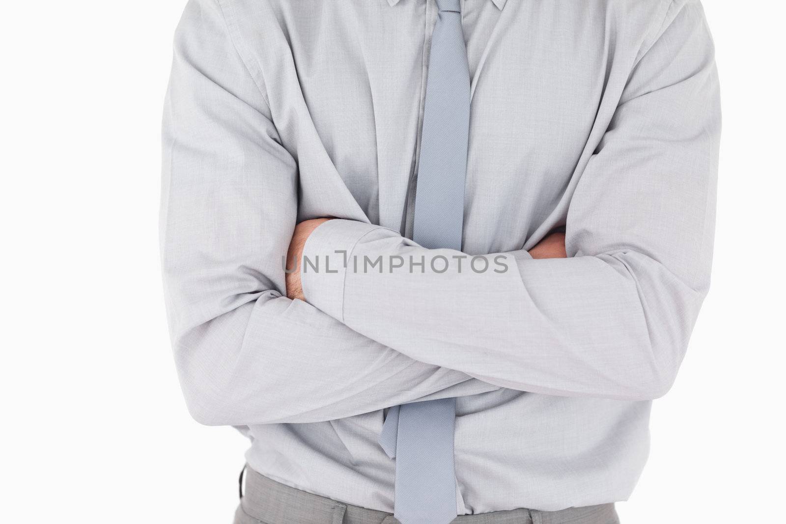Businessman with his arms crossed against a white background