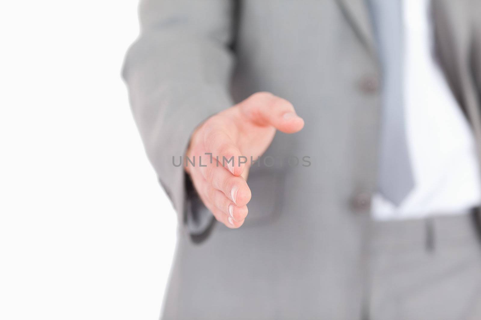 Businessman giving a helping hand against a white background