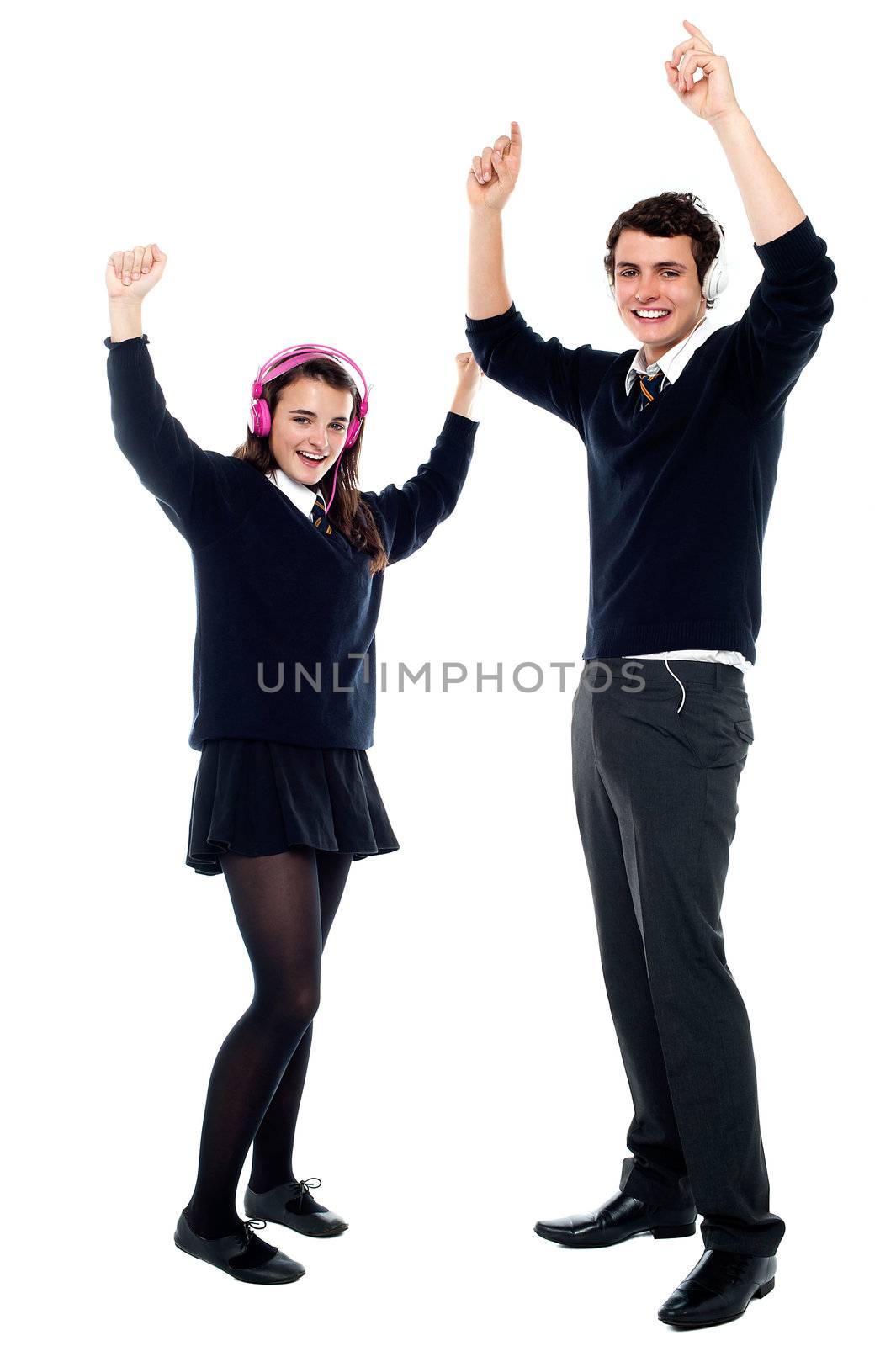 School going teenagers dancing to the beat by stockyimages