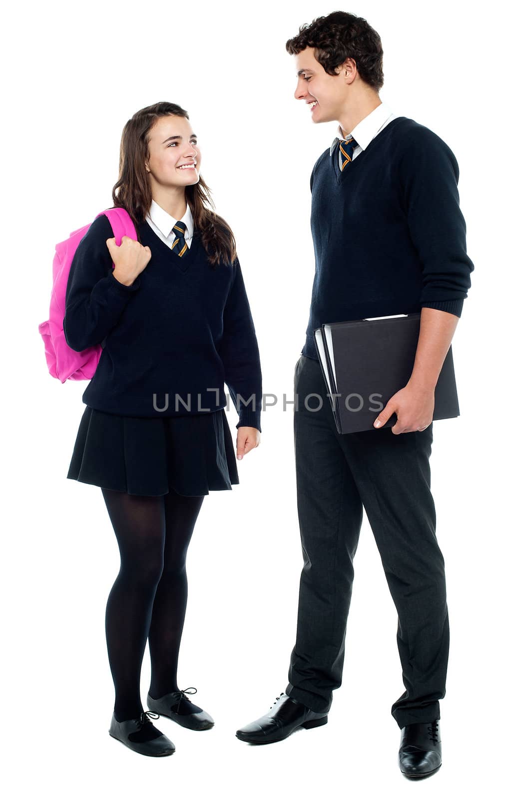 Casual shot of students looking at eachother and engaged in a jovial discussion isolated against white background