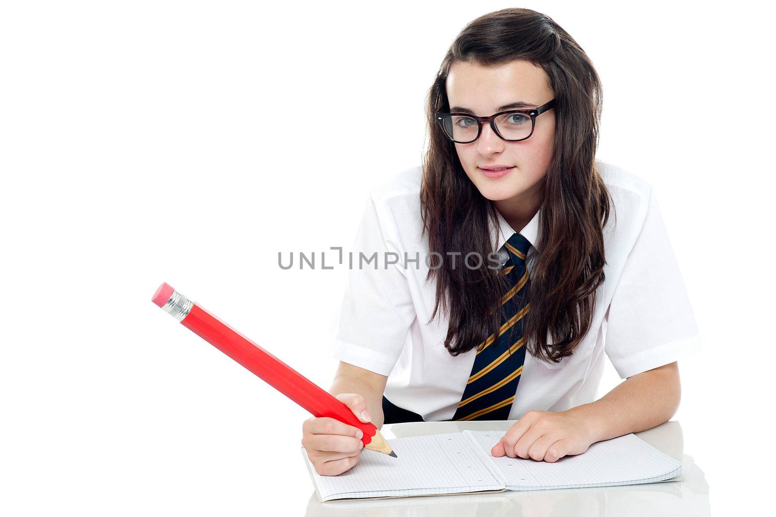 Snap shot of calm and relaxed young schoolgirl writing notes