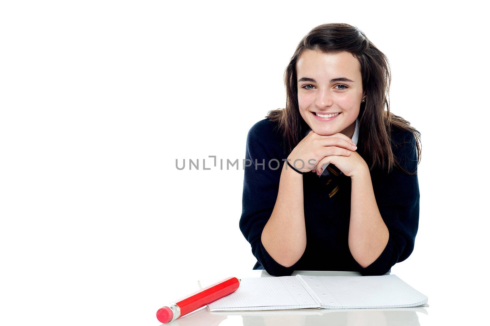 Attractive confident young schoolgirl posing in front of camera