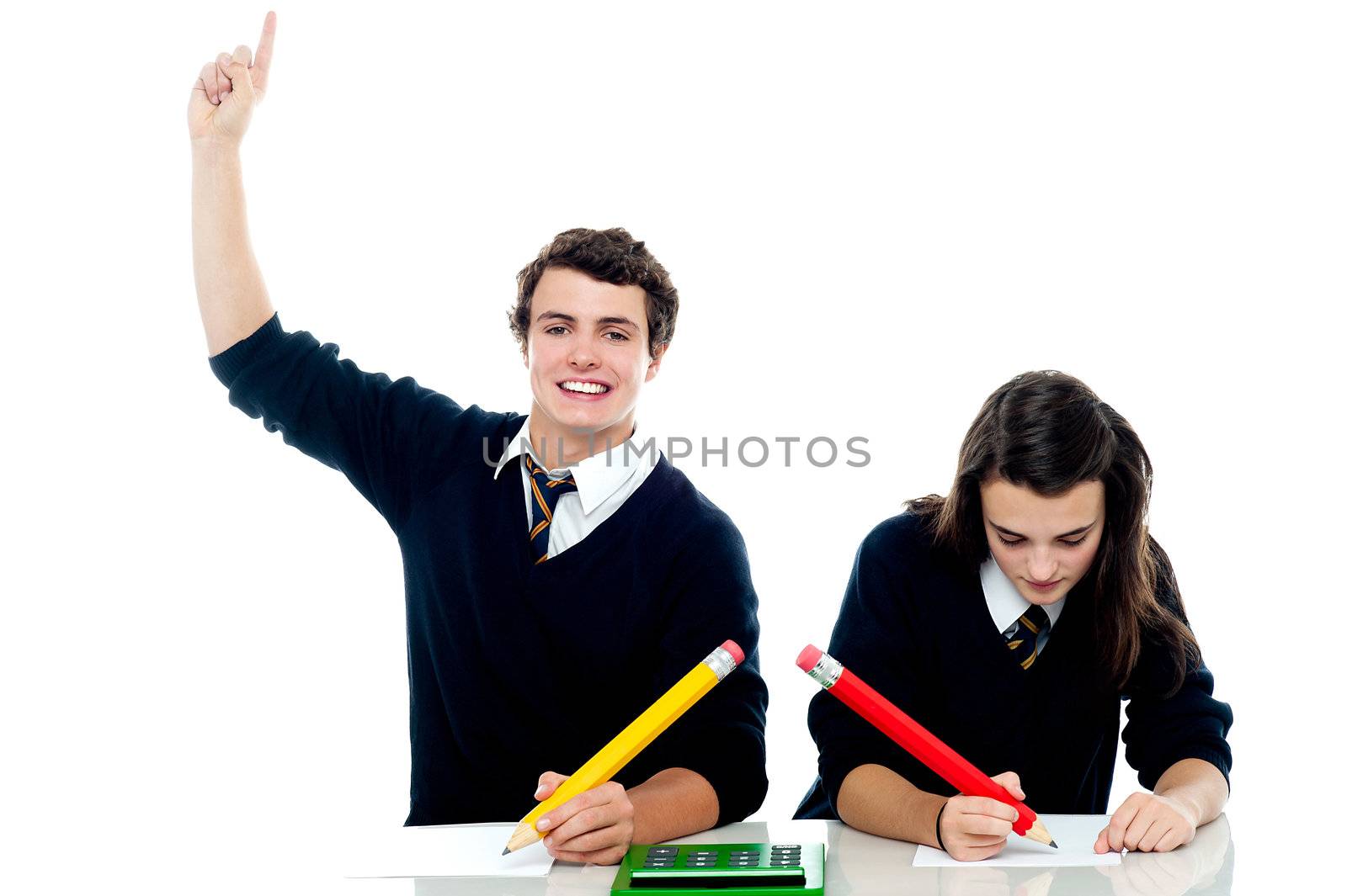 I am done with the test. Boy raises his hand while the girl is still busy writing