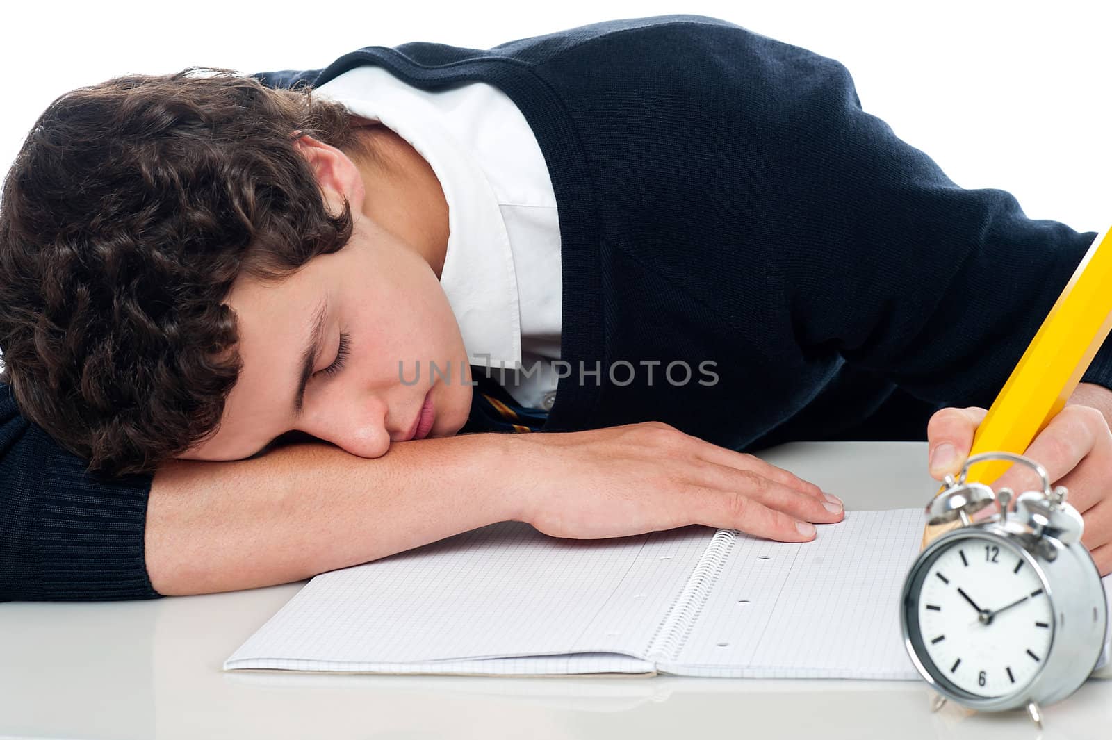 Teenager dozing off while writing his test. Fast asleep