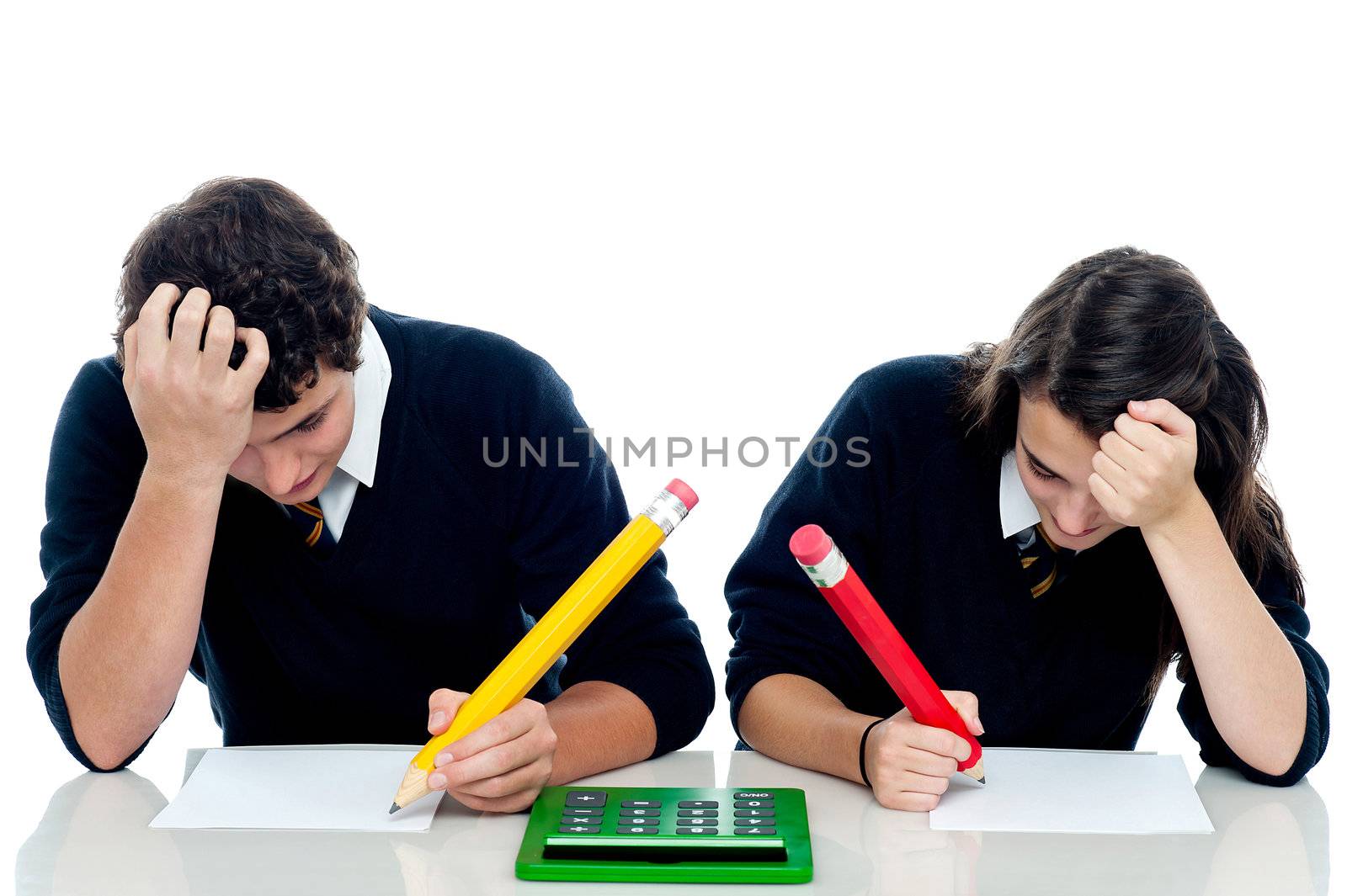 Students resting their arms on the desk, holding head and trying to recollect the answer