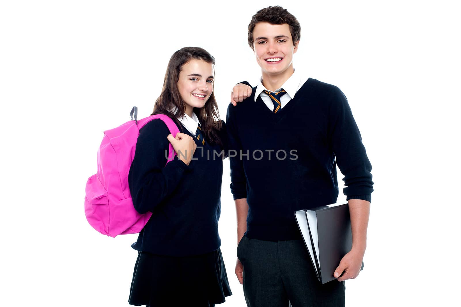 Girl resting her arm on classmates shoulder. Cheerfully posing in front of camera