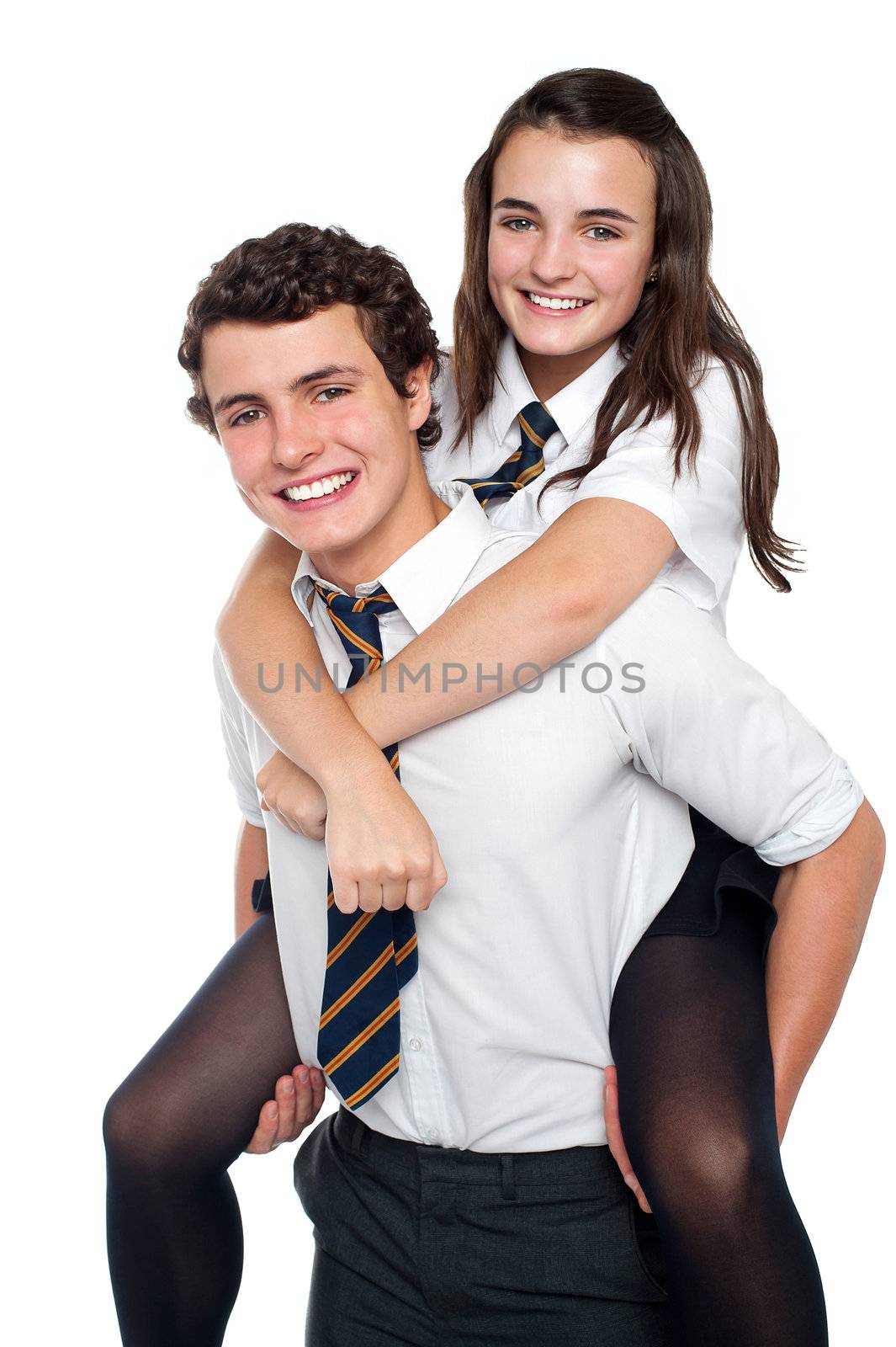 Cheerful shot of youngster riding piggyback in school uniform and having fun
