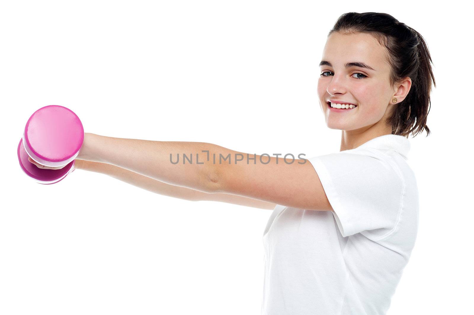 Side profile of an energetic girl with dumbbells in her outstretched arms