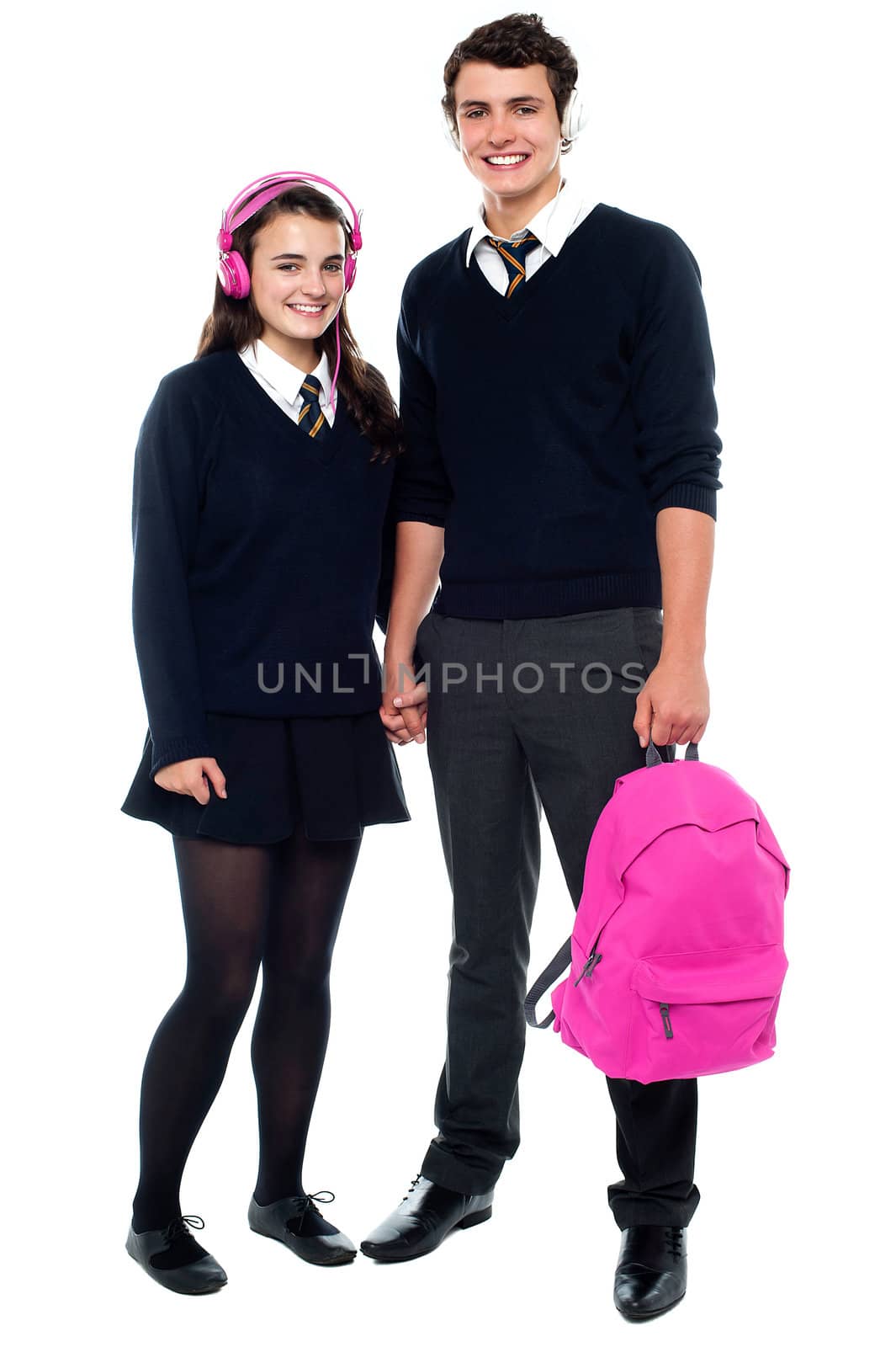 Boy holding pink backpack posing with female student by stockyimages