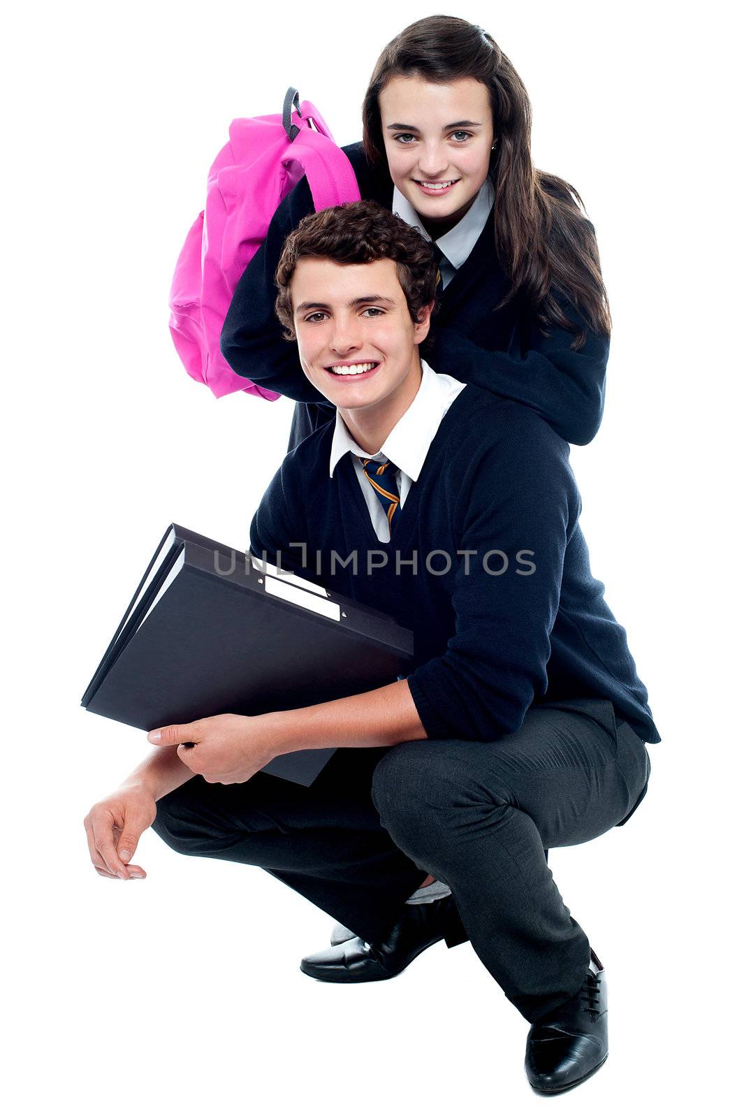 Adorable schoolmates posing together by stockyimages