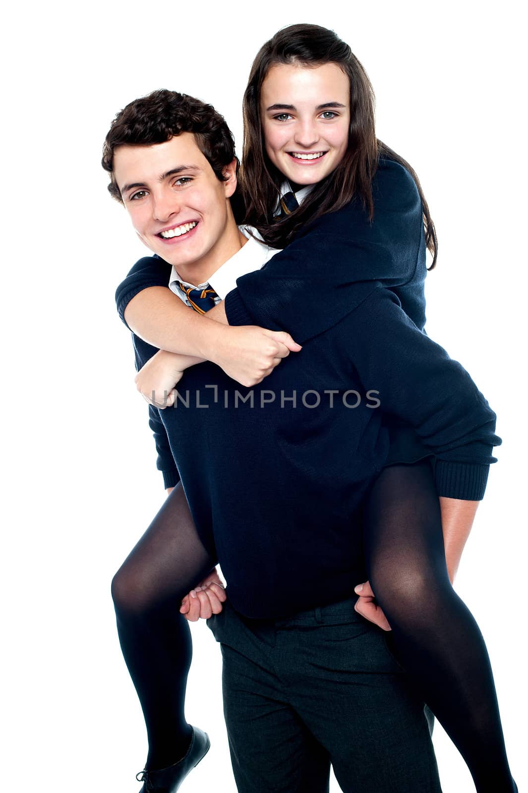 Girl riding piggyback and embracing boy tightly. All on white background
