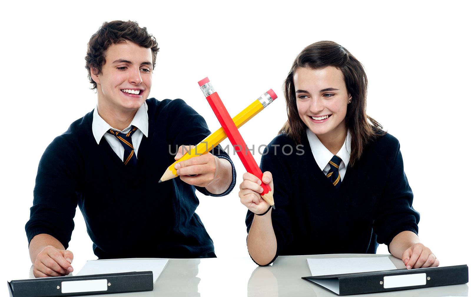 Classmates engaged in a mock fight by stockyimages