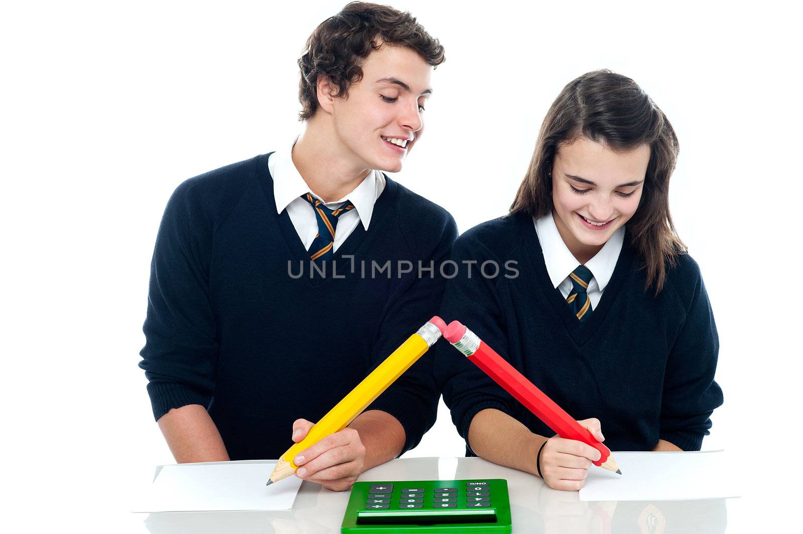 School boy copying from his fellow student by stockyimages