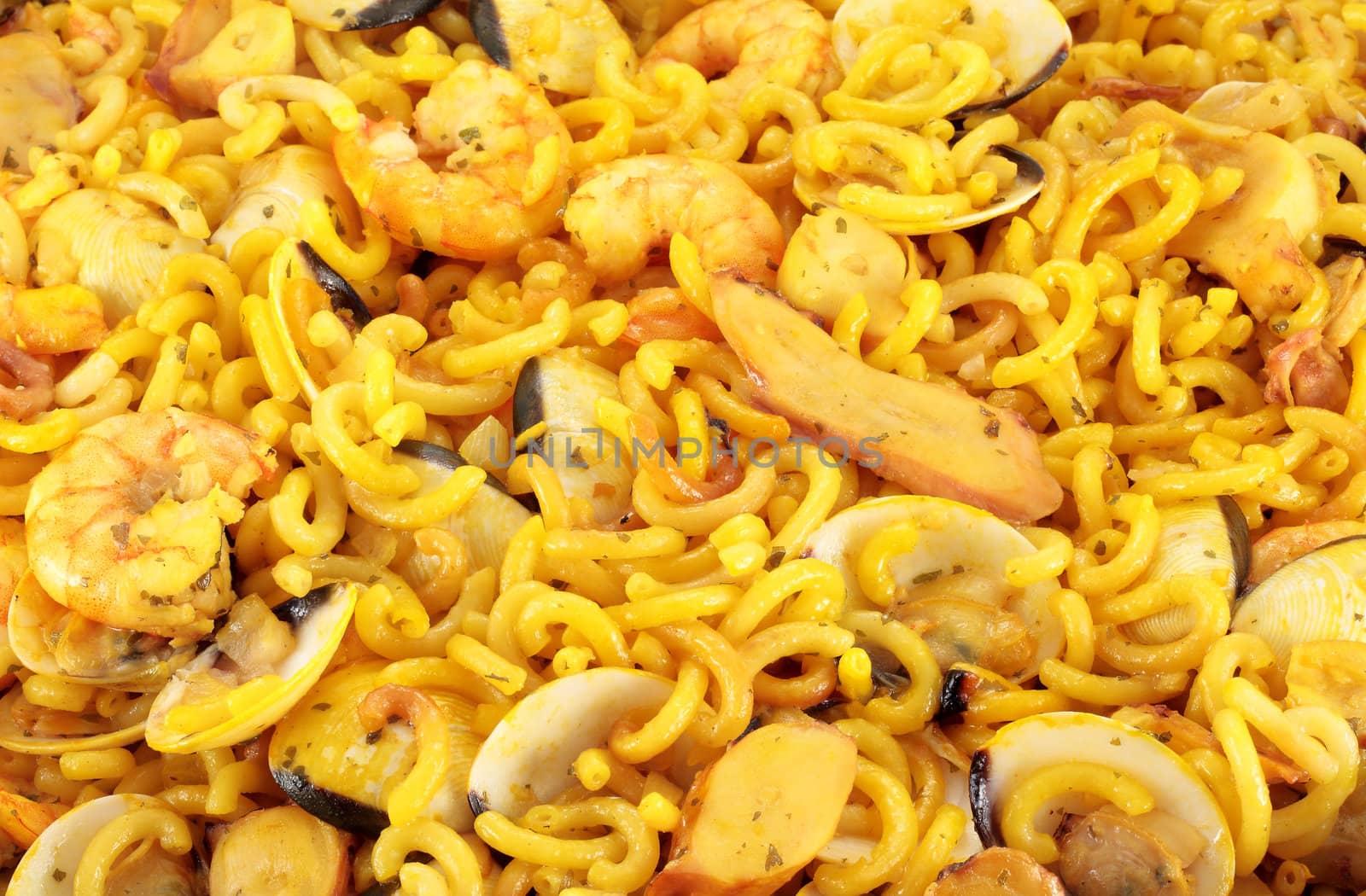 detail of typical Spanish food noodles with prawns clams squid and prawns