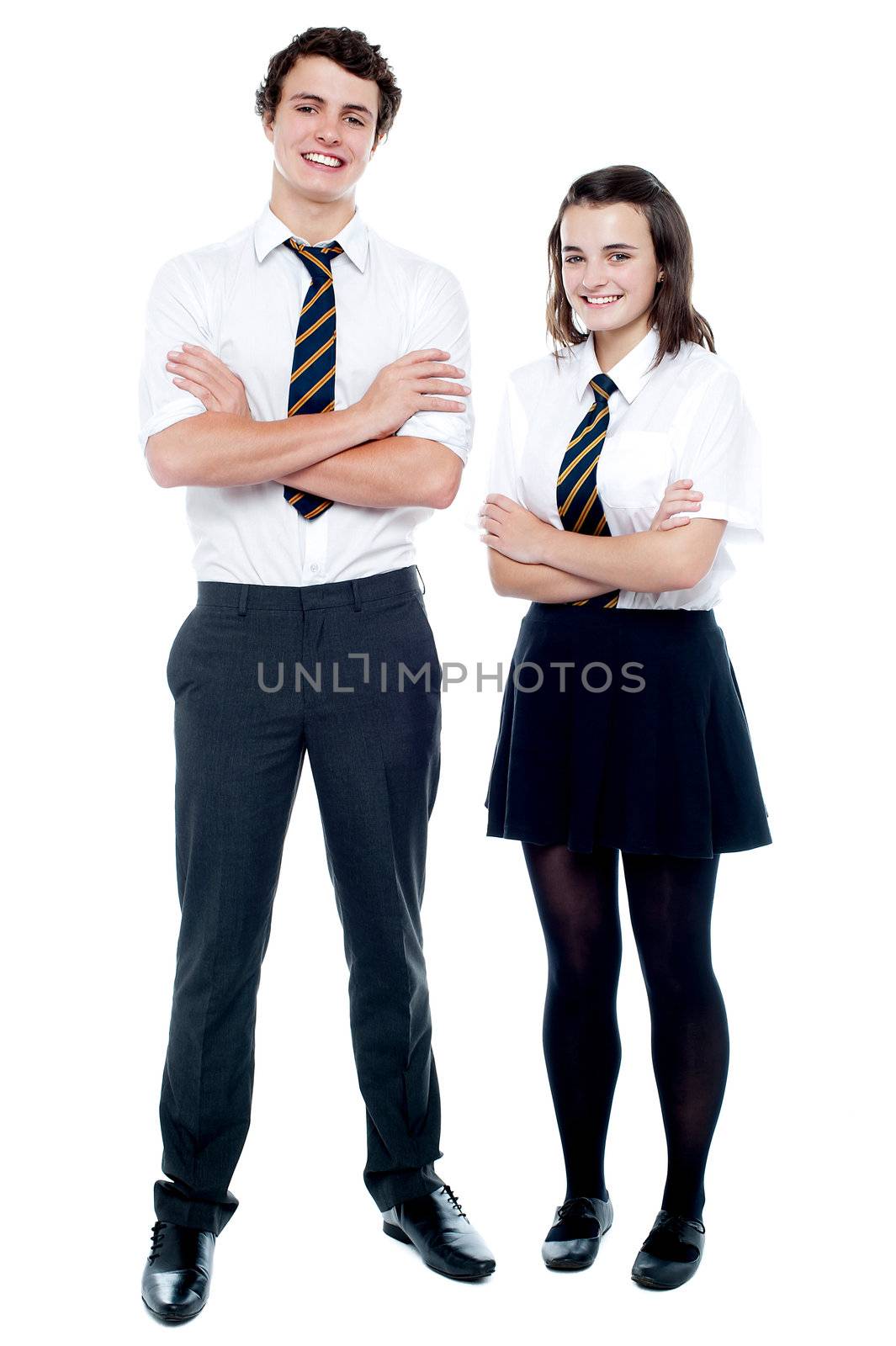 Full length portrait of teen students in uniform posing with arms crossed